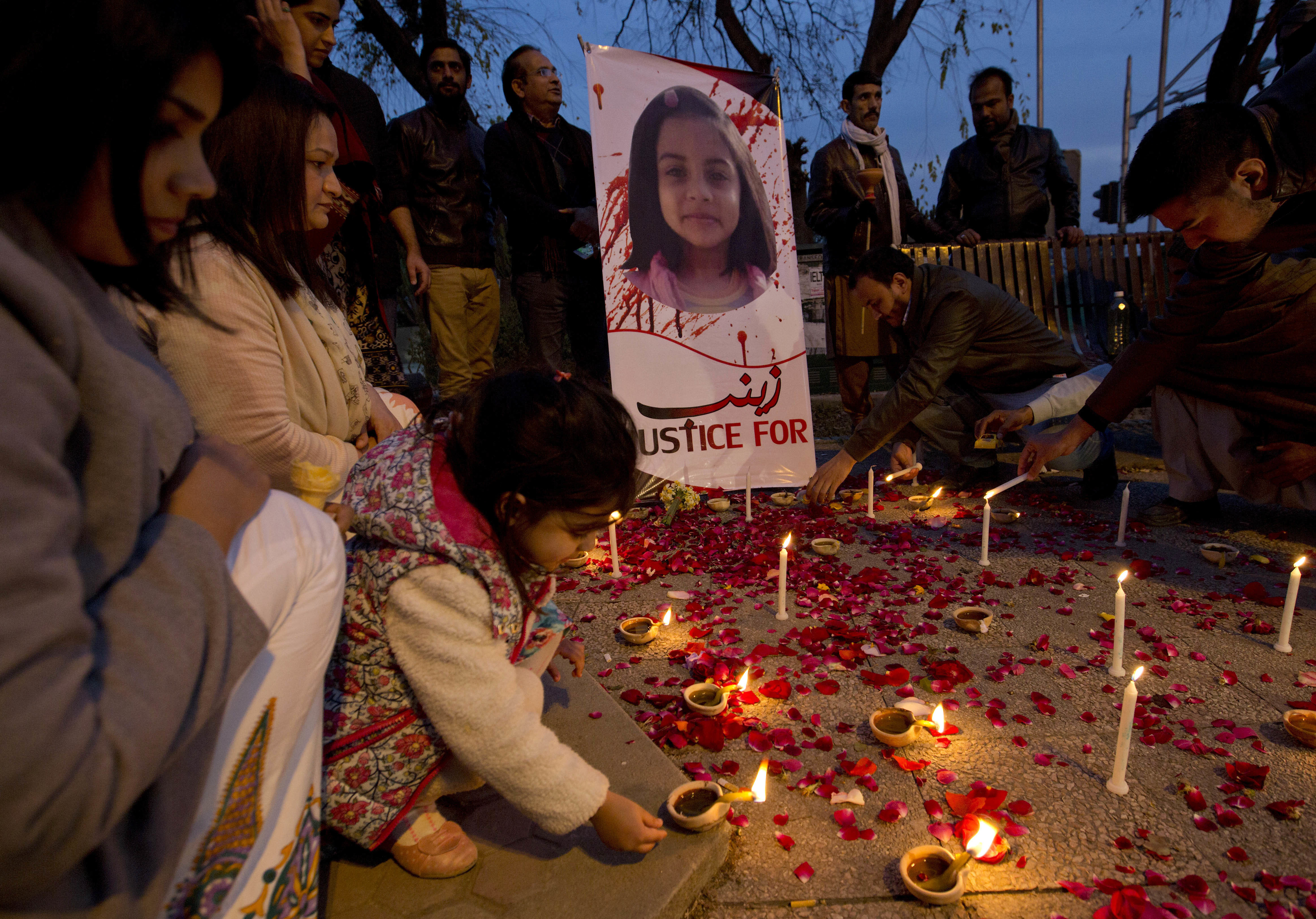 In this photo from January 11, 2018, a girl lights a candle during a memorial for Zainab Ansari in Islamabad, Pakistan [File: BK Bangash/AP Photo]