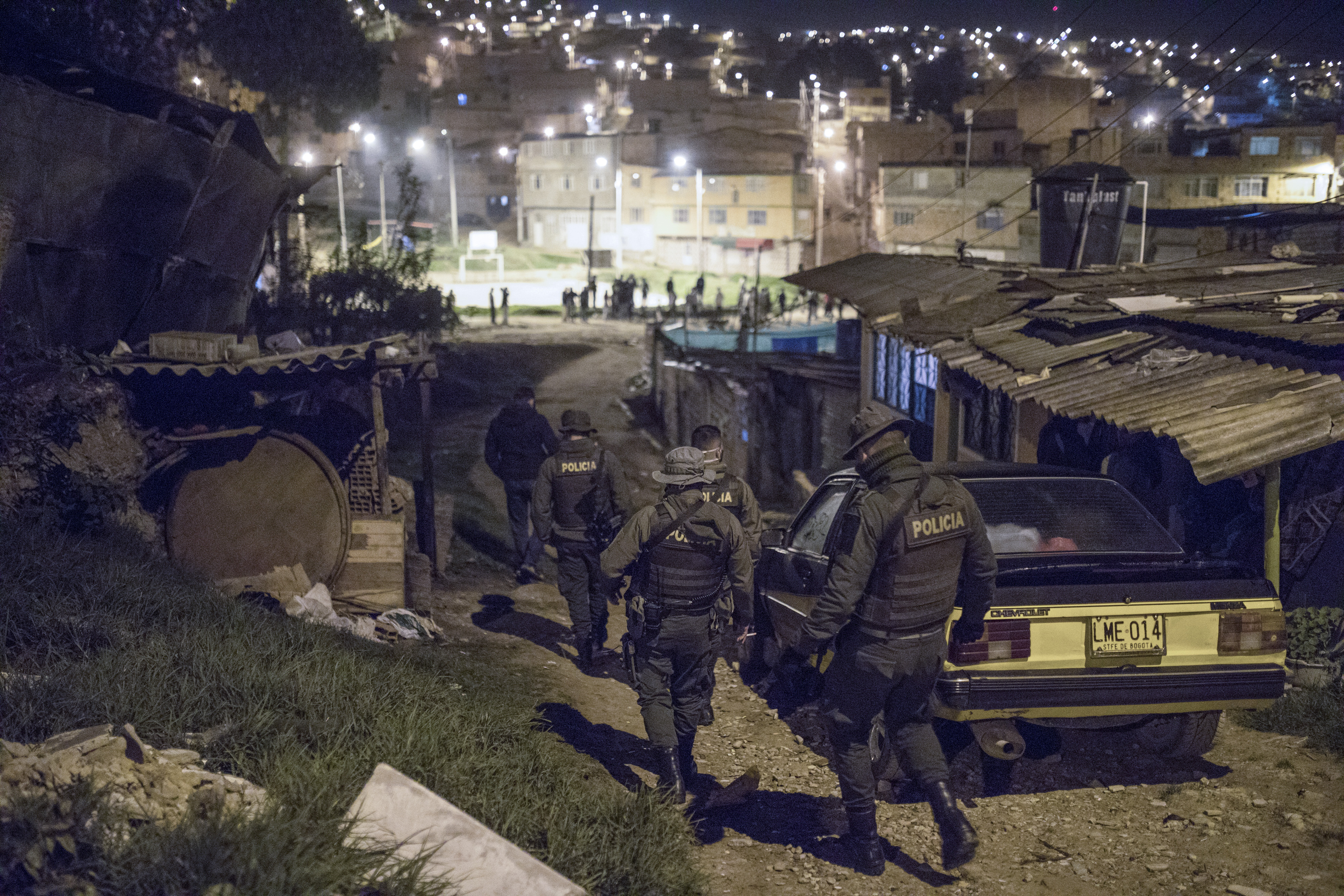Police officers patrolling a neighbourhood on the outskirts of Bogota [File: Ivan Valencia/AP Photo]