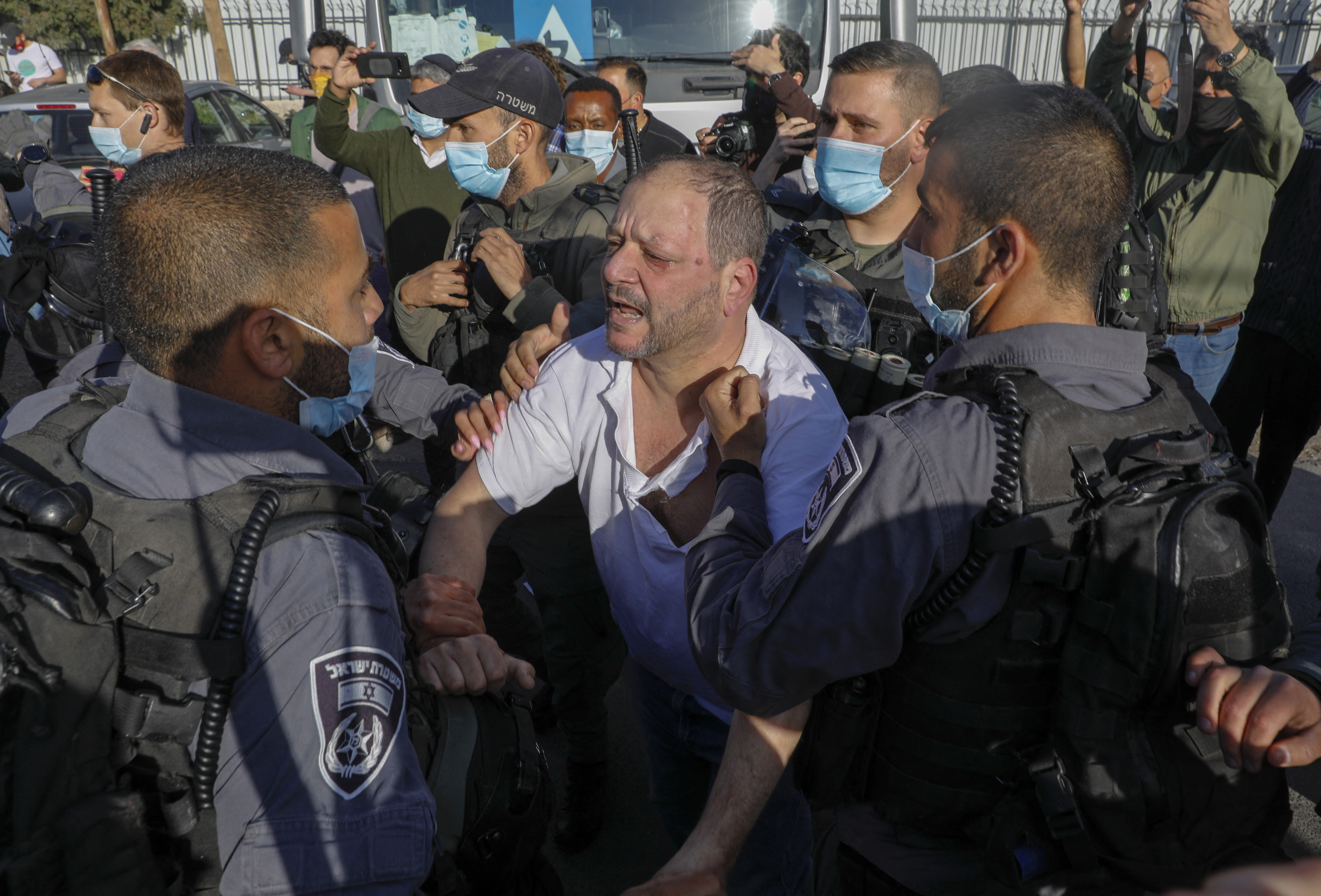 Israeli policemen detain Israeli MP Ofer Cassif, a Jewish member of the predominantly Arab Joint List electoral alliance, during a demonstration against Israeli occupation and settlement activity in Sheikh Jarrah, occupied East Jerusalem [Ahmad Gharabli/AFP]