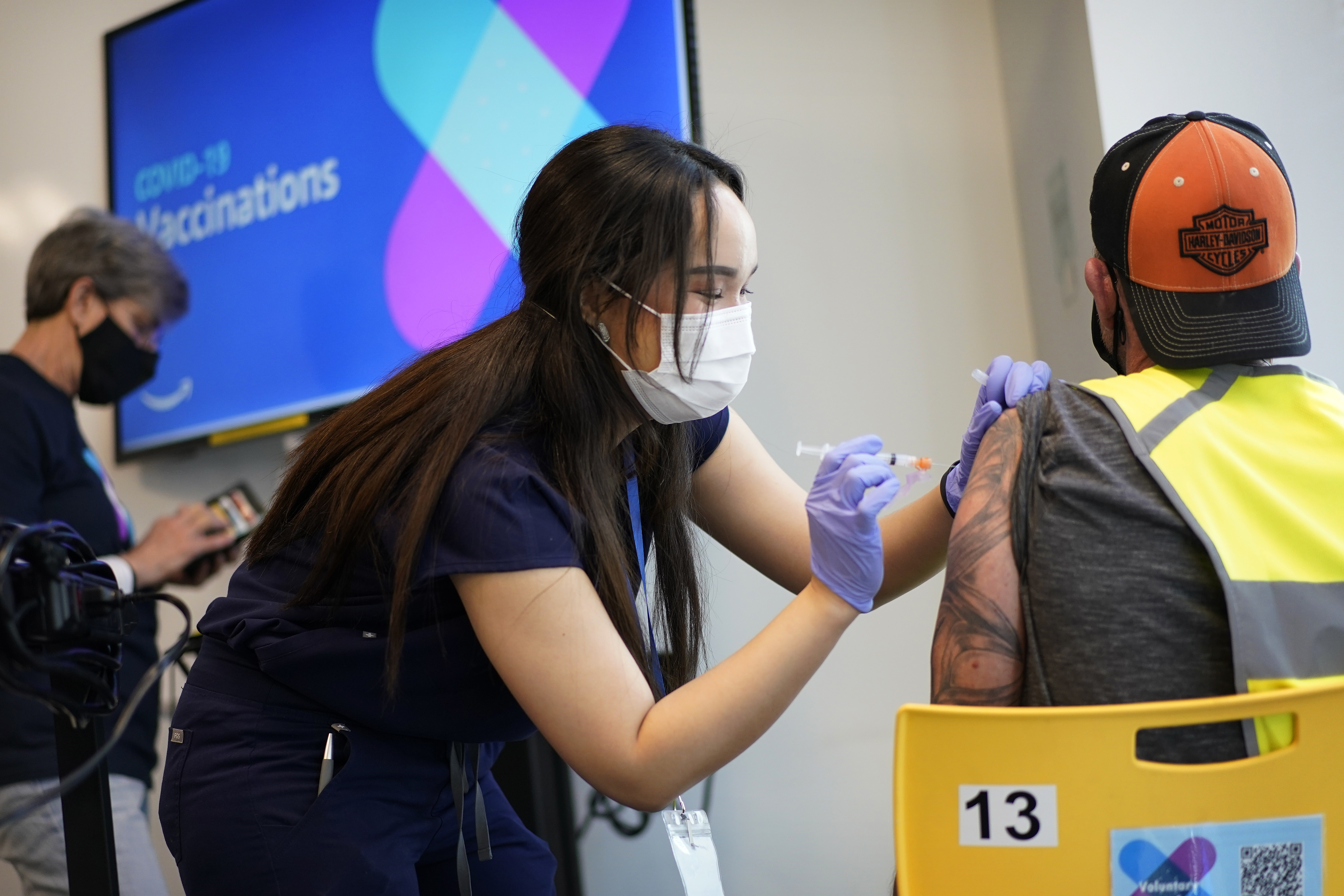 Registered nurse Sofia Mercado administers a vaccine shot at a vaccination event for workers at an Amazon Fulfillment Center, Wednesday, March 31, 2021, in North Las Vegas, Nev. A growing number of companies and labor unions are directly securing coronavirus vaccines for their workers. Amazon and some other large companies have hosted on-site inoculations, while smaller operations have helped book appointments for their workers. (AP Photo/John Locher) (AP Photo)