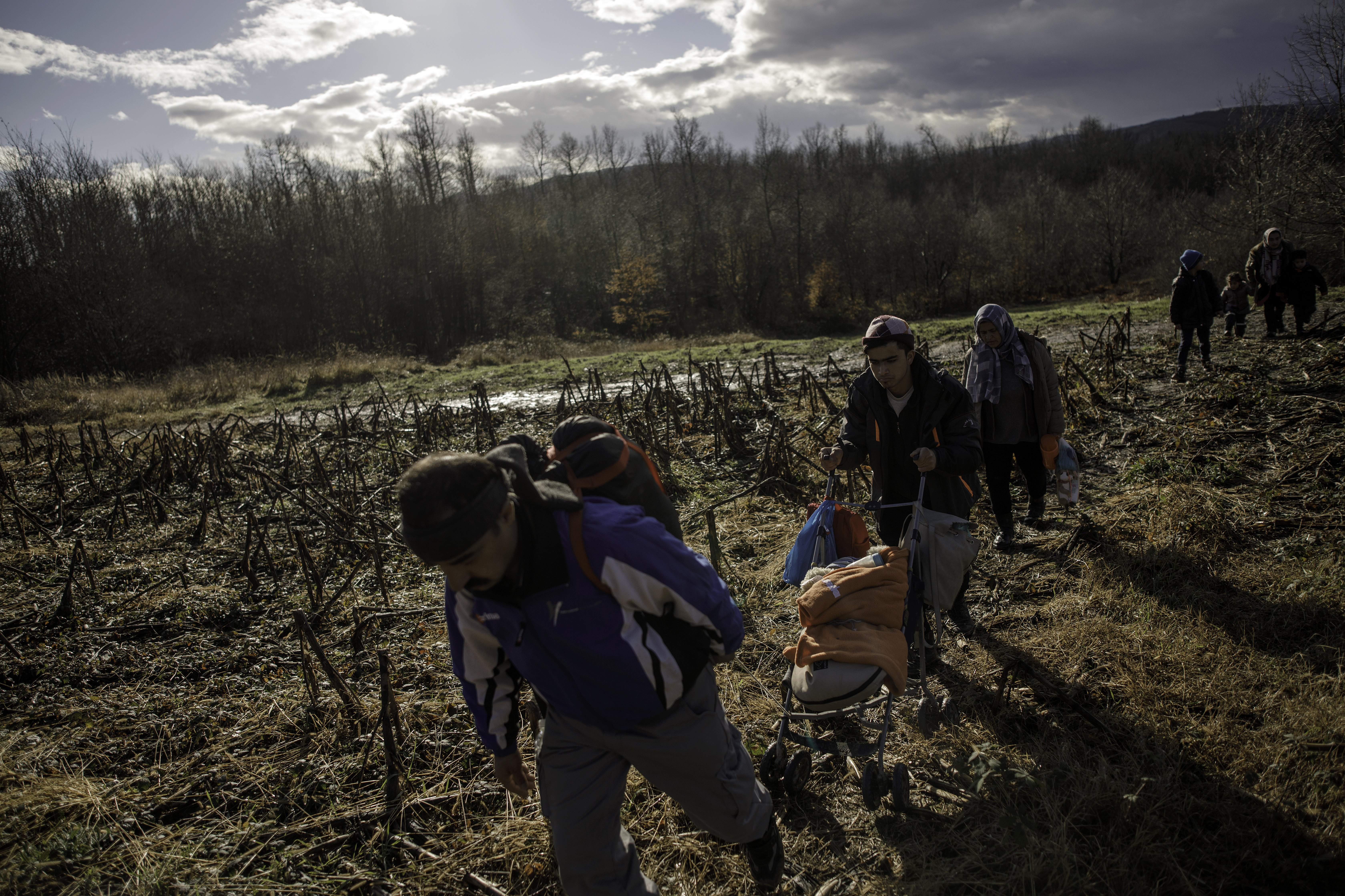 A baby is pushed in a stroller as members of a migrant family from Afghanistan approach Croatia&#39;s border from Bosnian side in an attempt to cross into EU by foot, on January 6, 2021 in Bosnia and Herzegovina [Damir Sagolj/Getty Images]