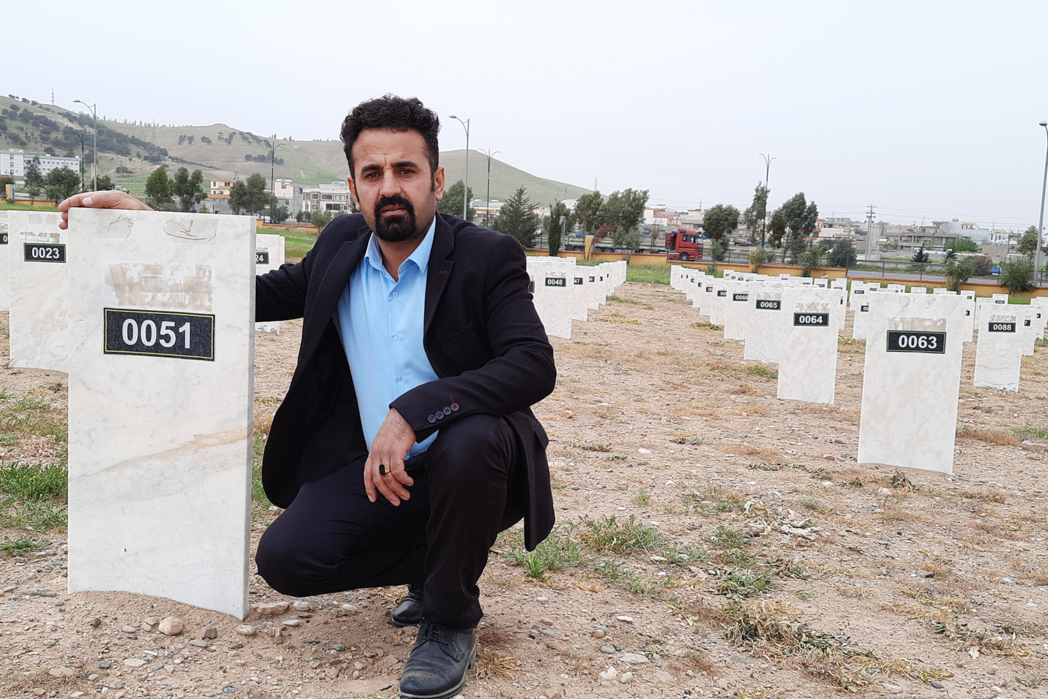 Qasm Kadhim inside the graveyard of Anfal victims in Chamchamal [Dana Taib Menmy/Al Jazeera]