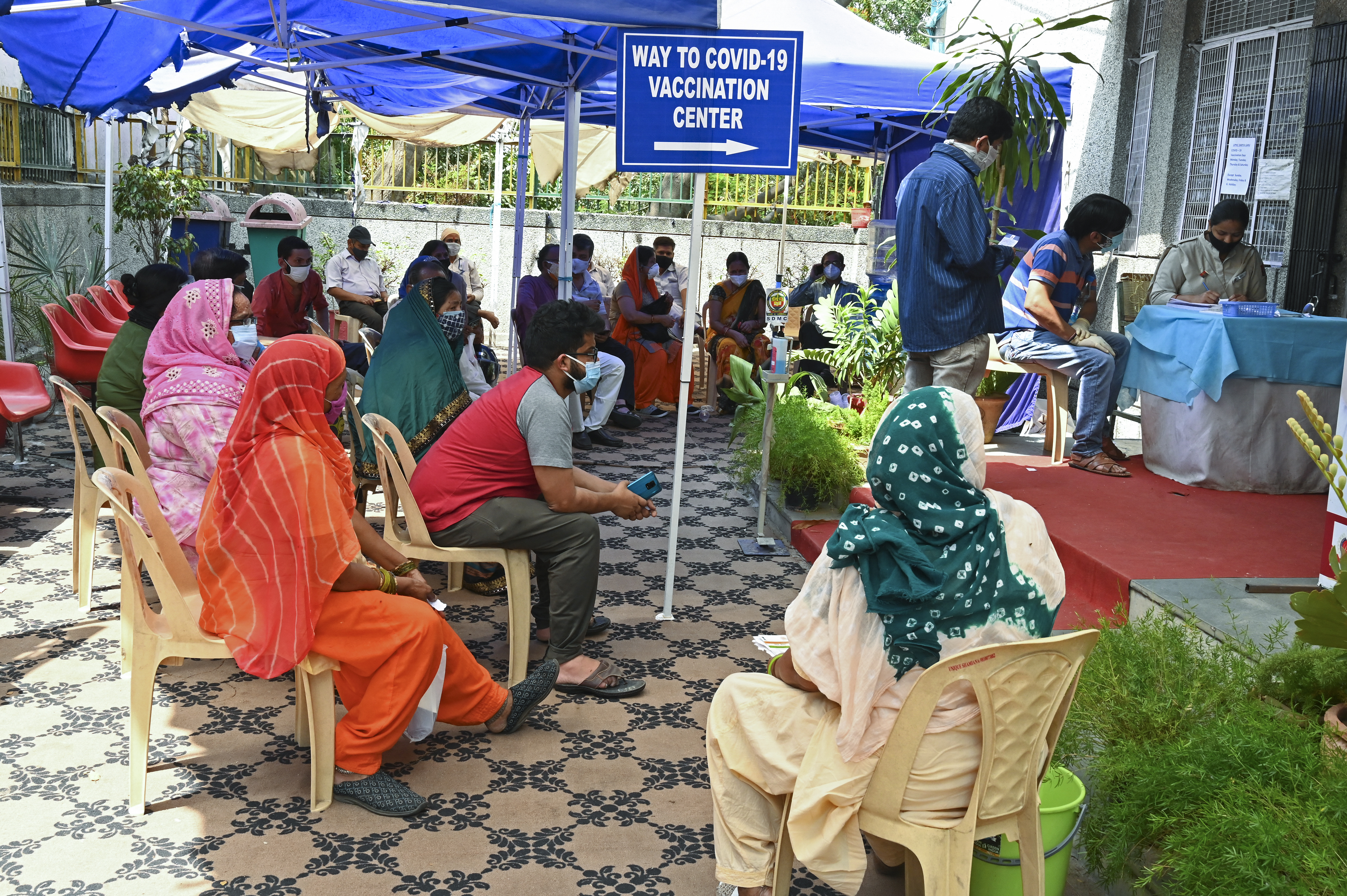 People wait to receive a dose of the Covishield coronavirus vaccine at a health centre in New Delhi on May 3, 2021 [Tauseef Mustafa/AFP]