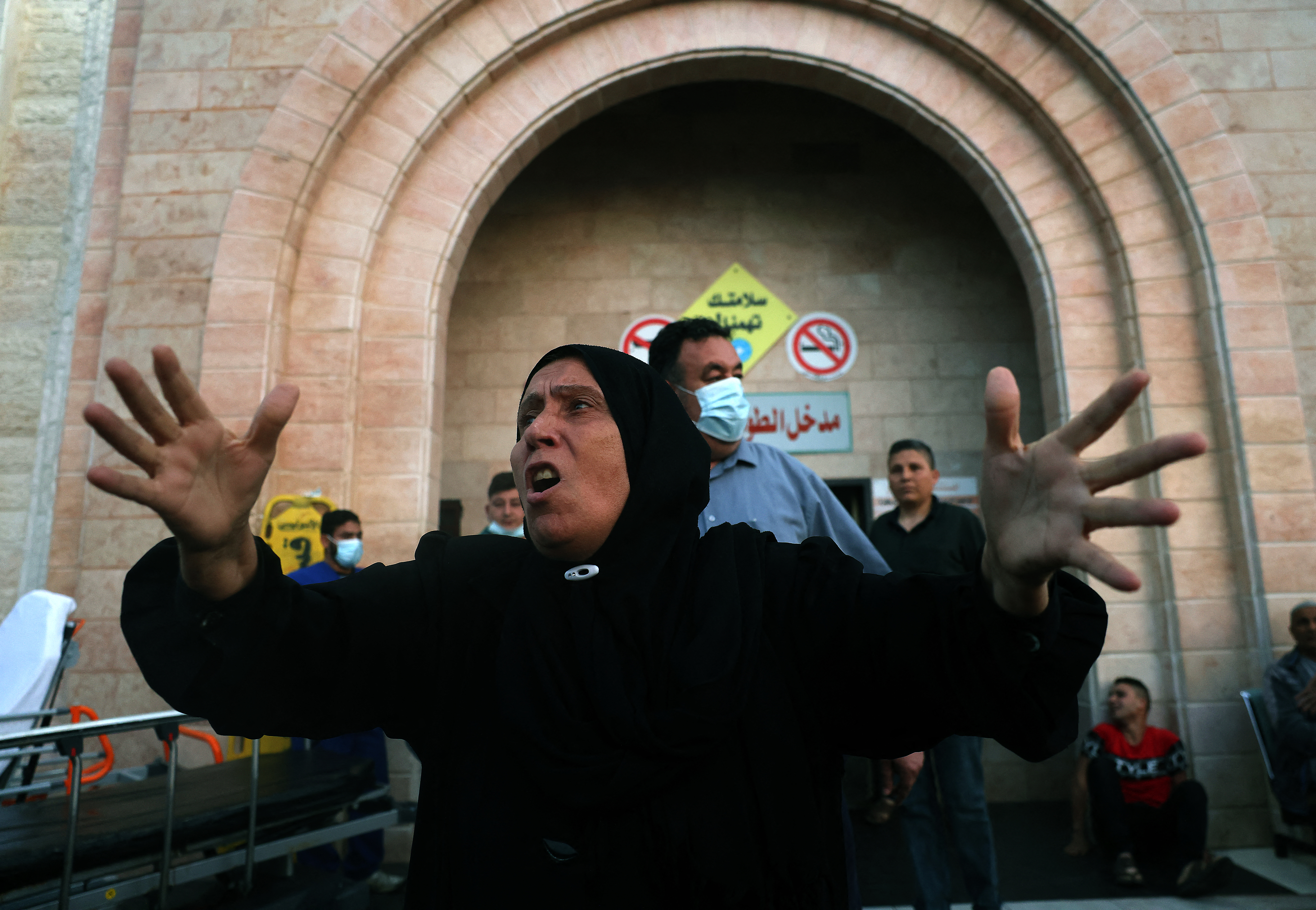 A Palestinian woman reacts outside a hospital in the northern Gaza Strip [Mohamed Abed/AFP]