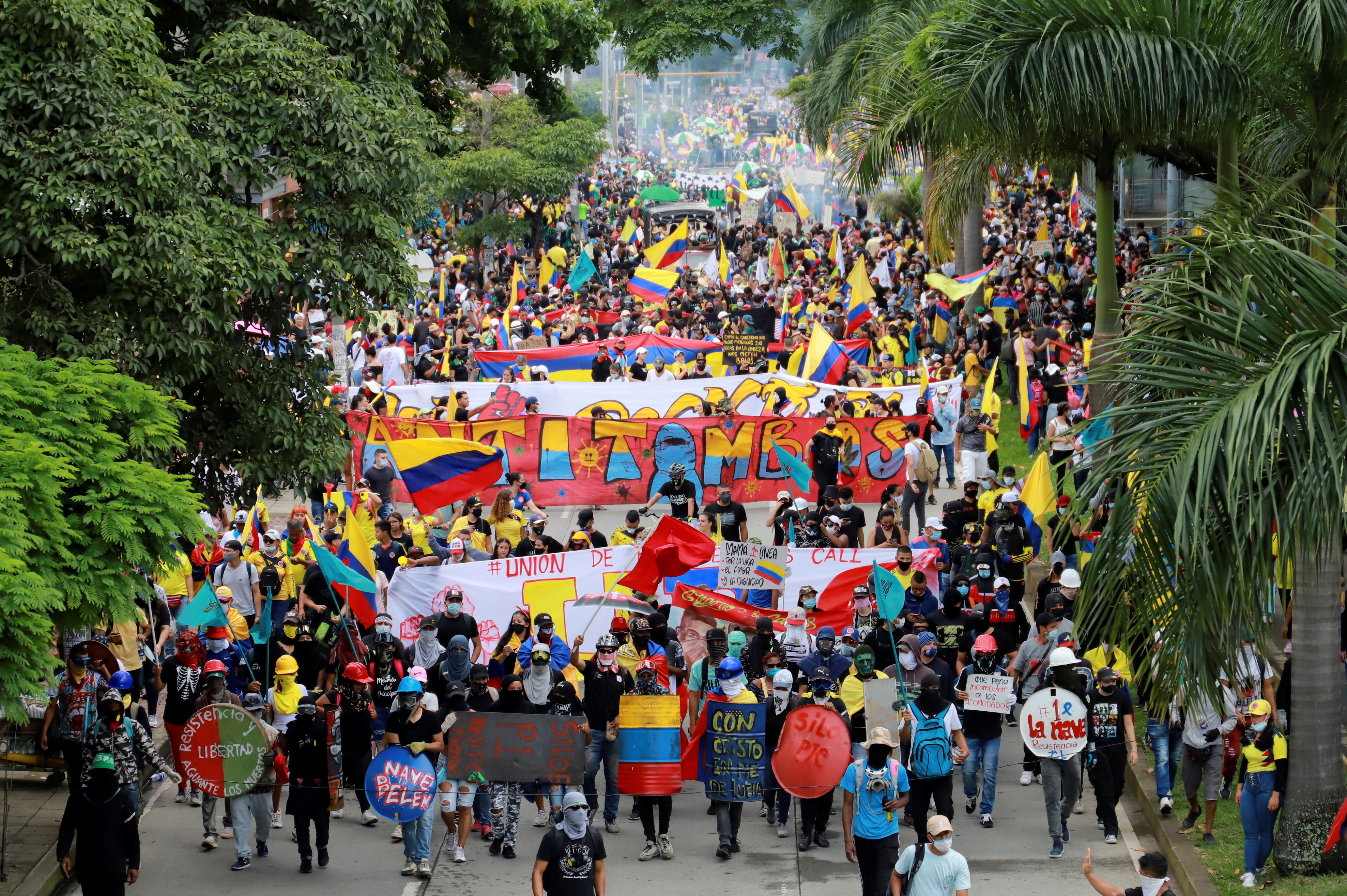 People take part in a protest demanding government action to tackle poverty, police violence and inequalities in healthcare and education systems, in Cali, Colombia May 28, 2021 [Juan B Diaz/ Reuters]