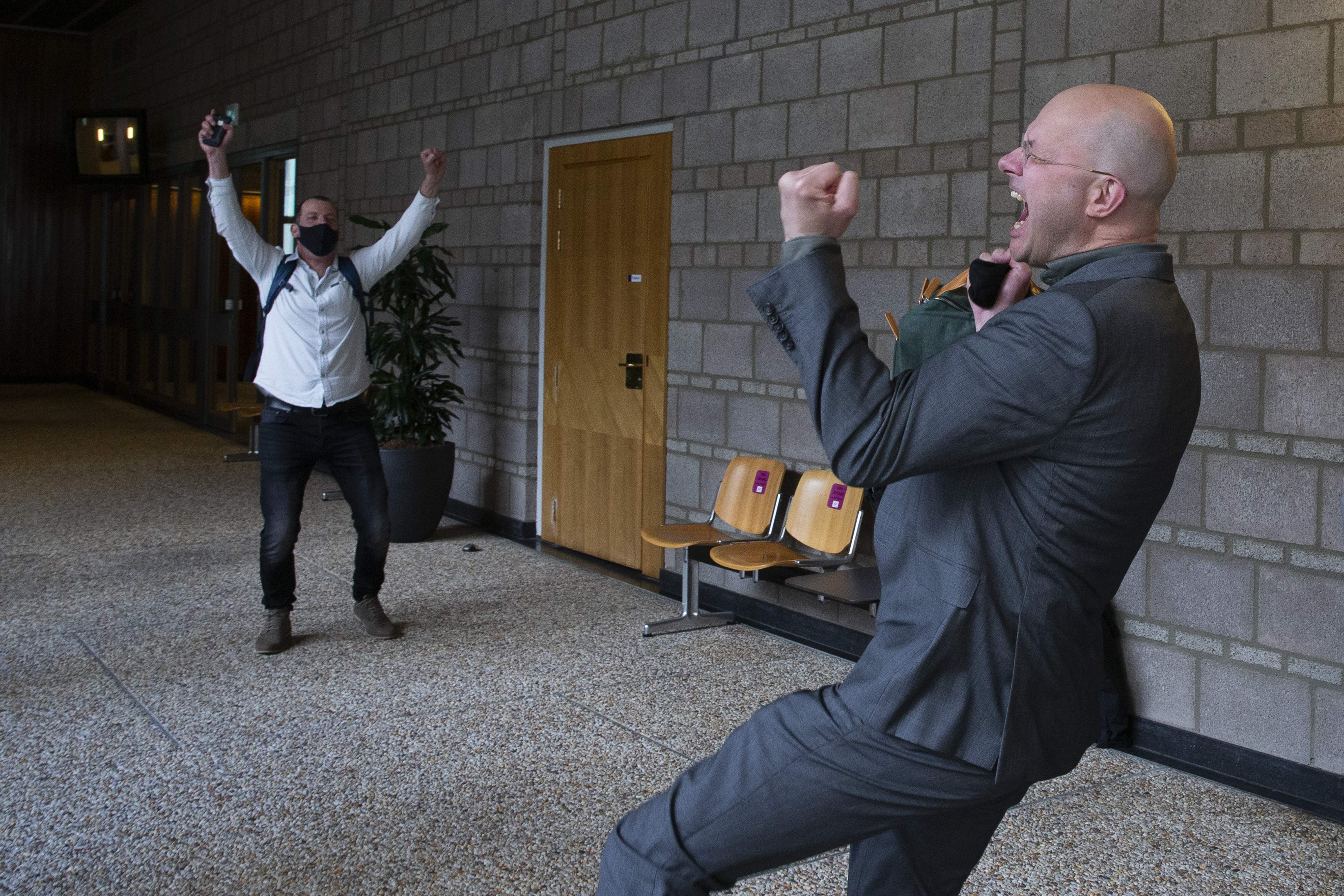 Milieudefensie director Donald Pols, right, celebrates the outcome of the verdict in the court case of Milieudefensie, the Dutch arm of the Friends of the Earth environmental organisation, against Royal Dutch Shell in The Hague, the Netherlands on Wednesday [Peter Dejong/AP]
