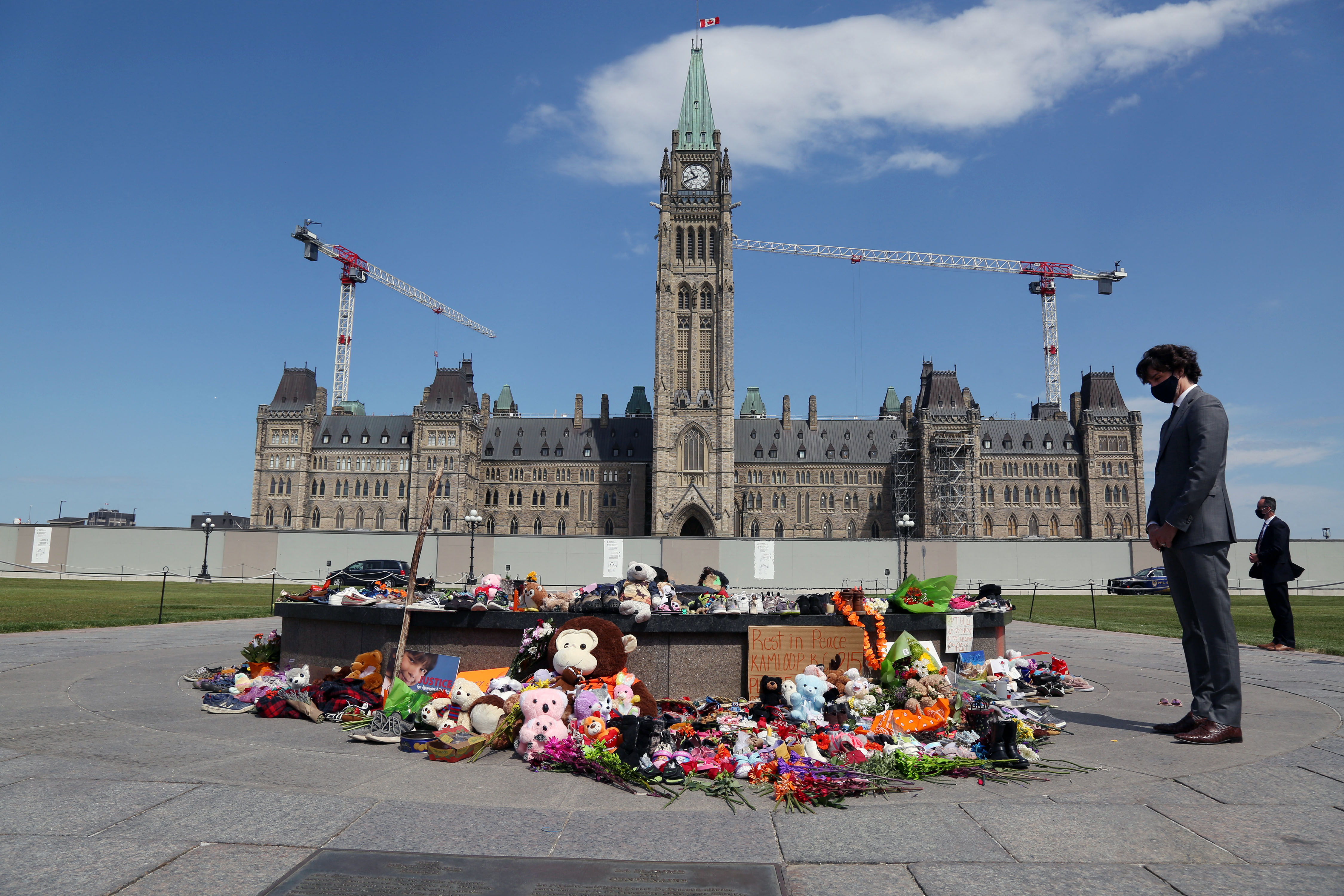 Trudeau visits the makeshift memorial erected in honour of the 215 Indigenous children whose remains were found at a &#39;residential school&#39; in British Columbia, on Parliament Hill June 1, 2021 in Ottawa [Dave Chan/AFP]