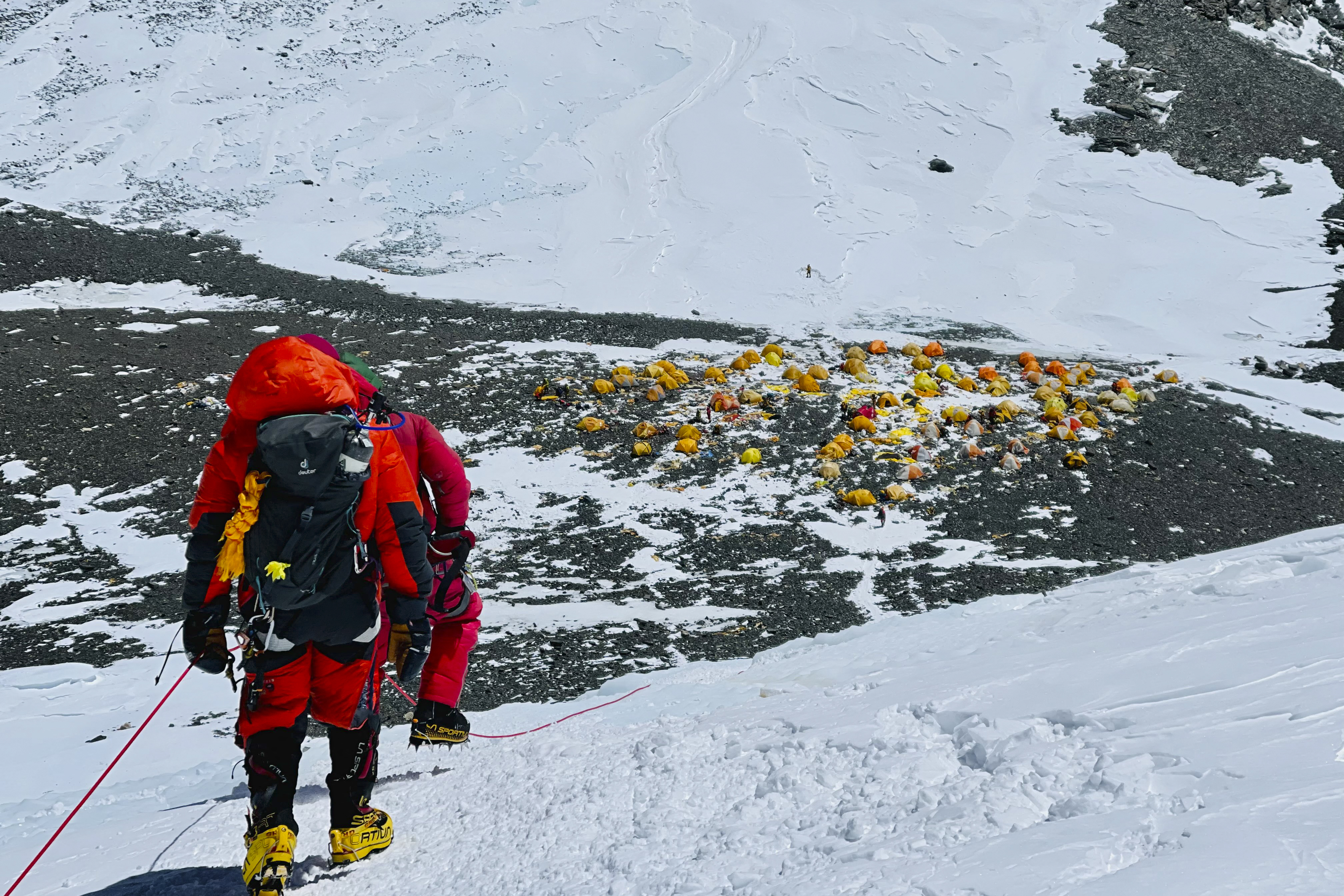 This photograph taken on May 31, 2021 shows mountaineers looking back at Camp 4 during their ascent to the summit of Mount Everest in Nepal [Lakpa Sherpa/ AFP]
