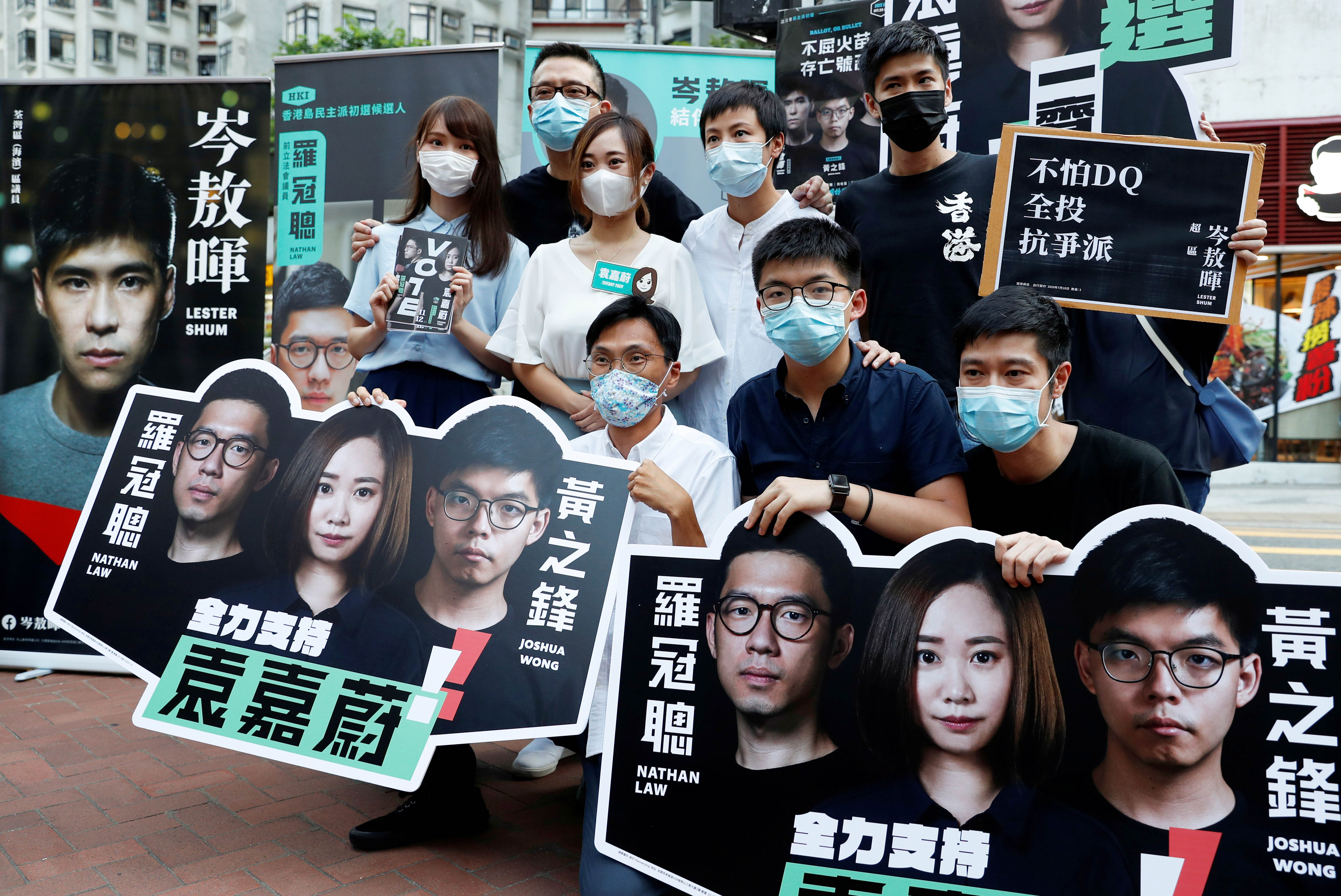Agnes Chow, Anthony Wong Yiu Ming, Tiffany Yuen Ka-wai, Denise Ho Wan See, Lester Shum, Eddie Chu, Joshua Wong and Gregory Wong pose for photo at a campaigning during primary elections aimed at selecting pro-democracy candidates, in Hong Kong on July 11, 2020 [File: Reuters/Tyrone Siu]
