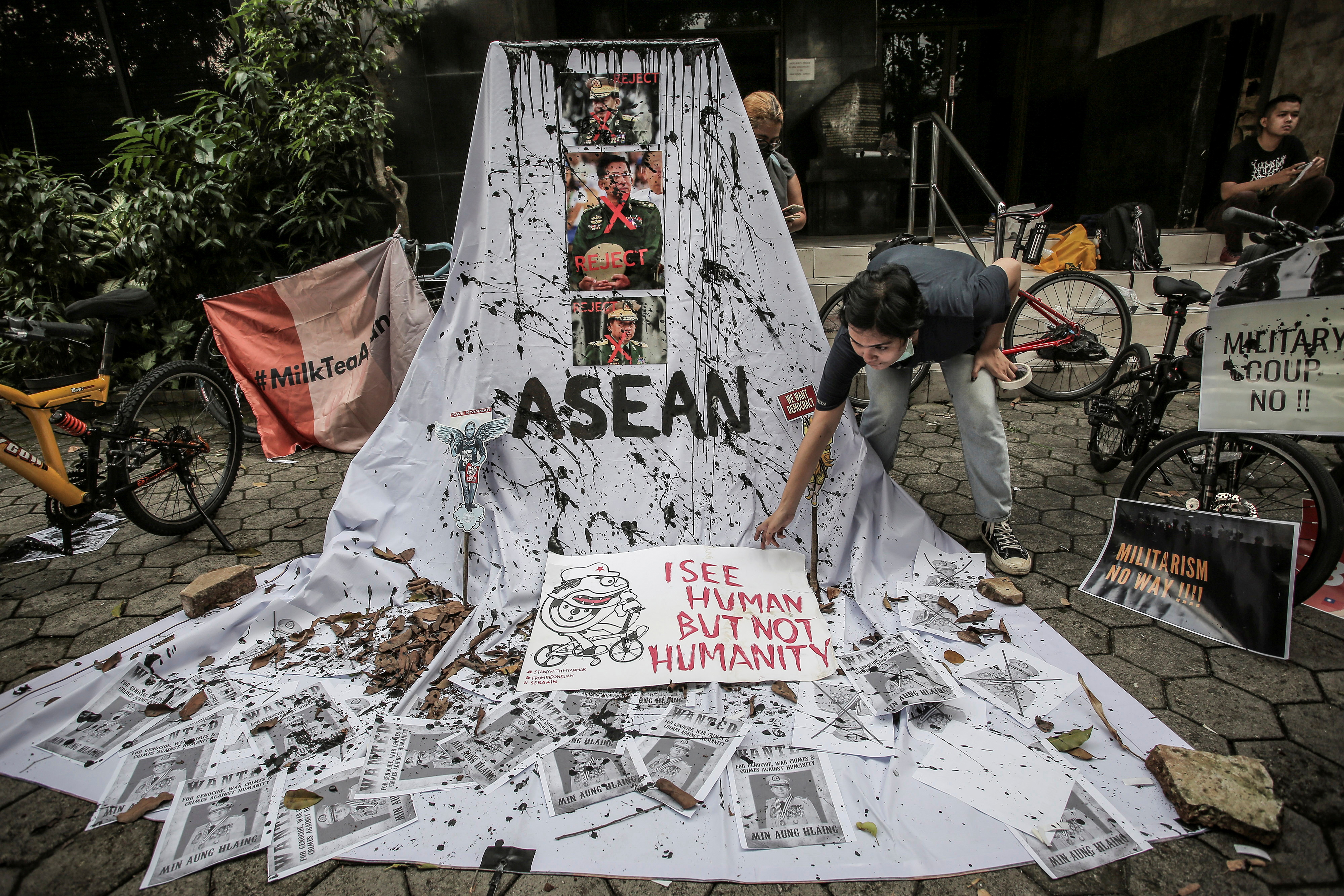 A woman prepares a placard from crossed out portraits of Myanmar&#39;s military chief Senior General Min Aung Hlaing during protests against the military coup in Myanmar, in Jakarta, Indonesia, on April 24, 2021 [Antara Foto/Dhemas Reviyanto/ via Reuters]