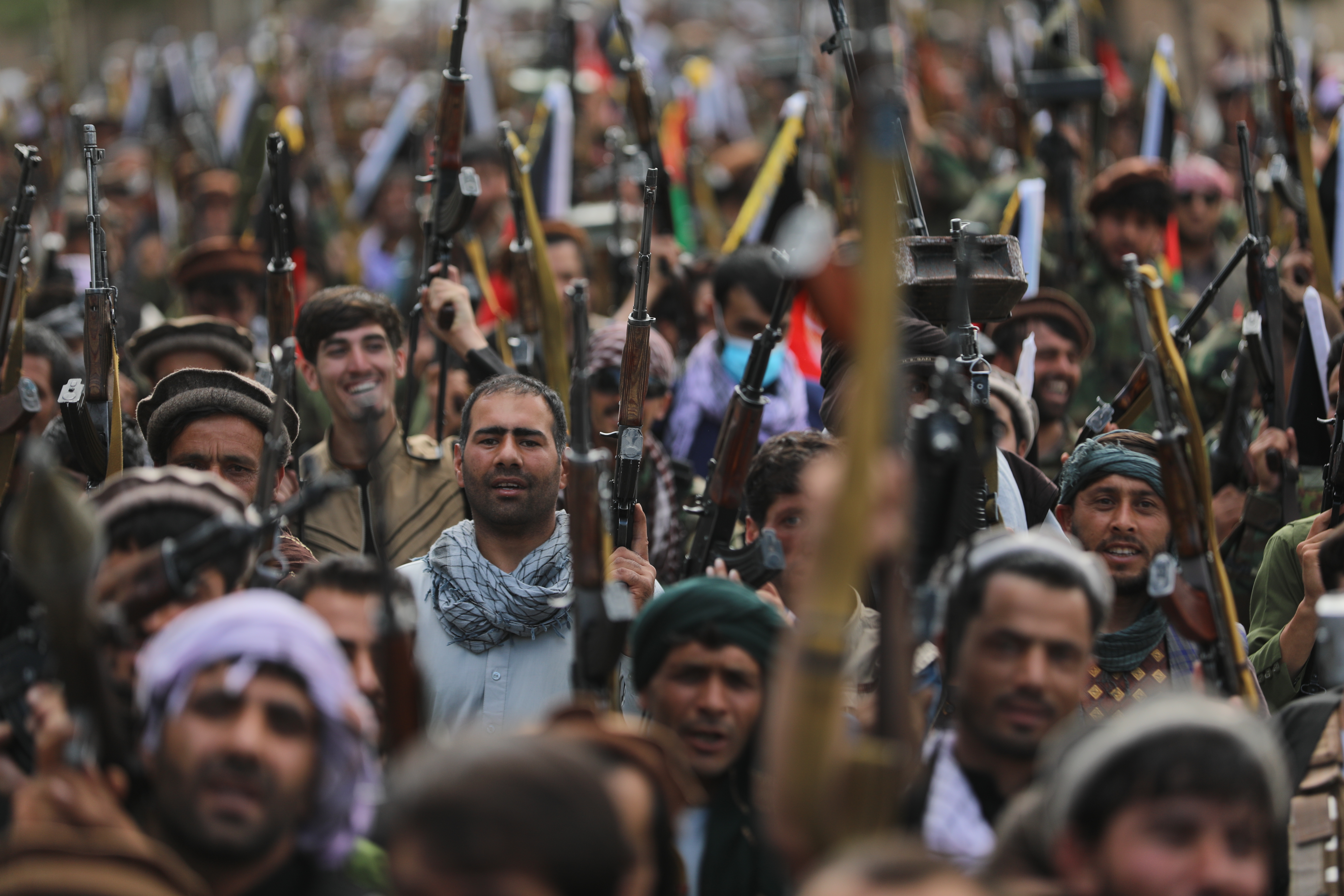 Afghan militiamen join Afghan defence and security forces during a gathering in Kabul [Rahmat Gul/AP]