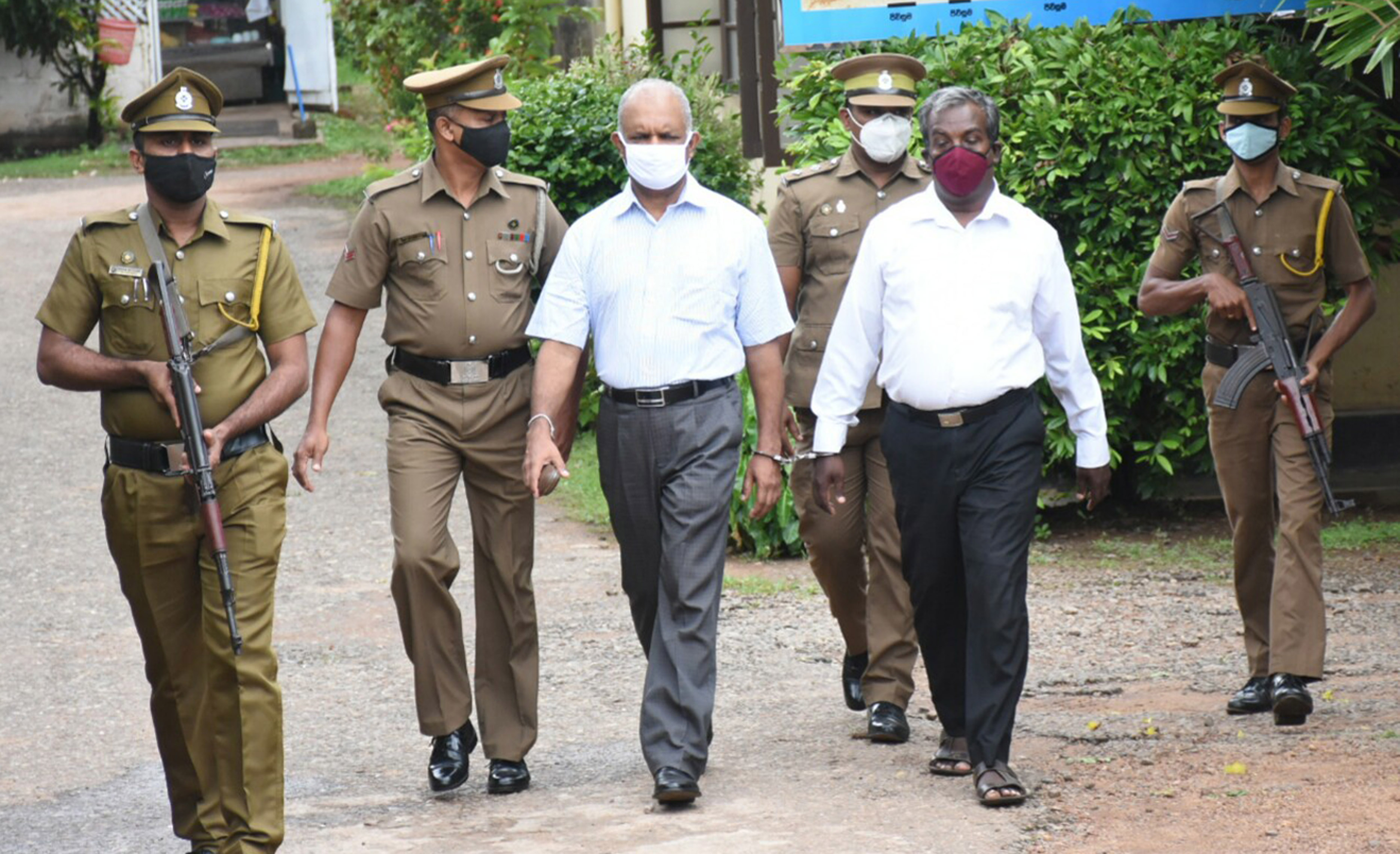 Shani Abeysekara, third from left, arriving in a court in Gampaha, Sri Lanka [File: Al Jazeera]