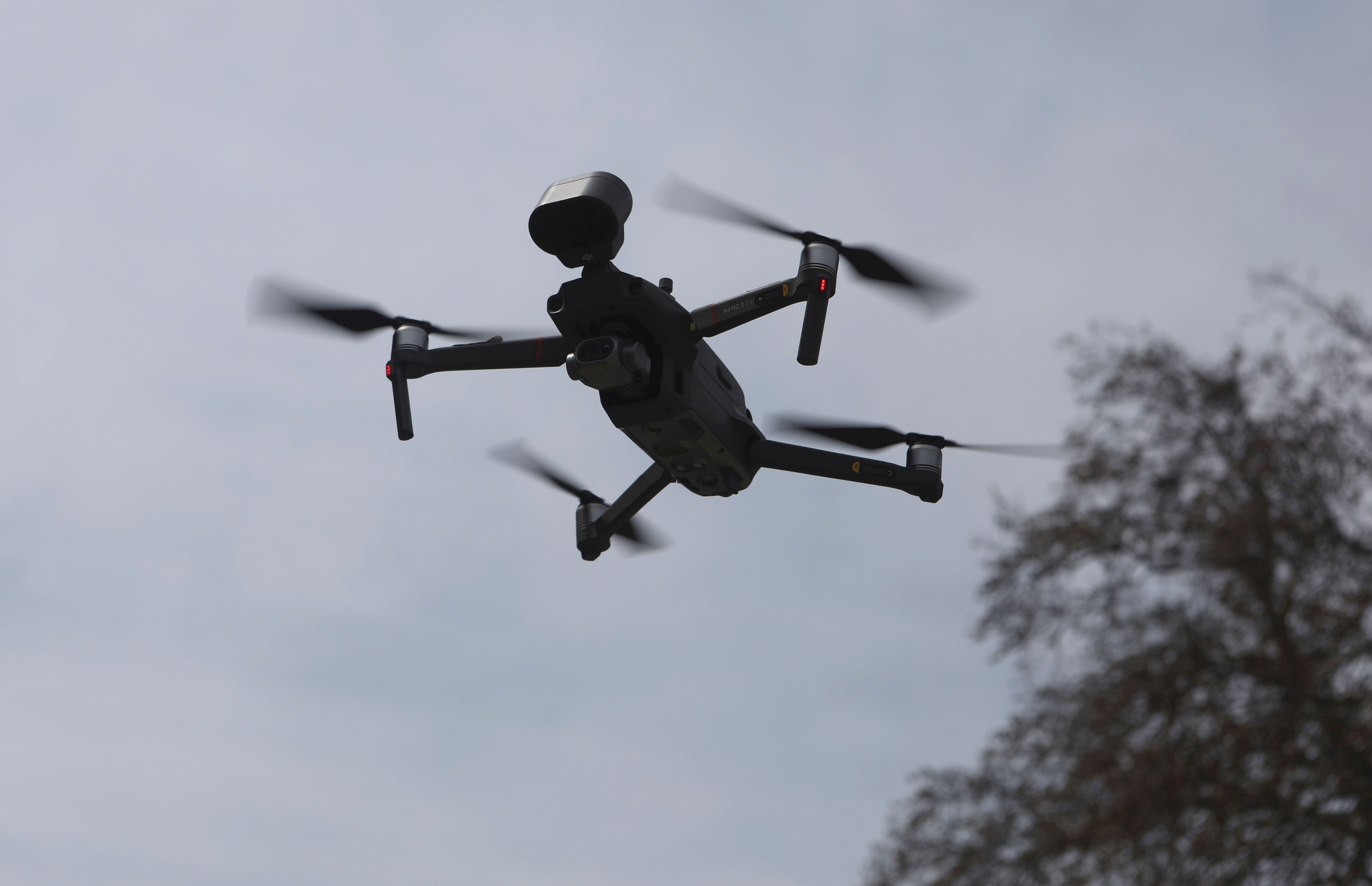 A drone hovers in air to announce COVID restrictions in Indian-administered Kashmir [File: Farooq Khan/EPA]