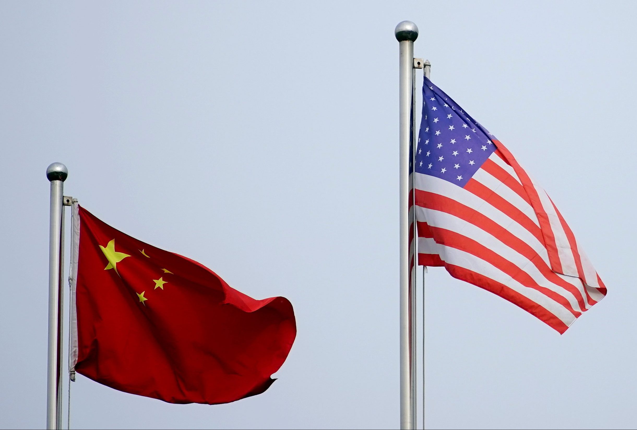 The flags of China and the United States flying next to each other.