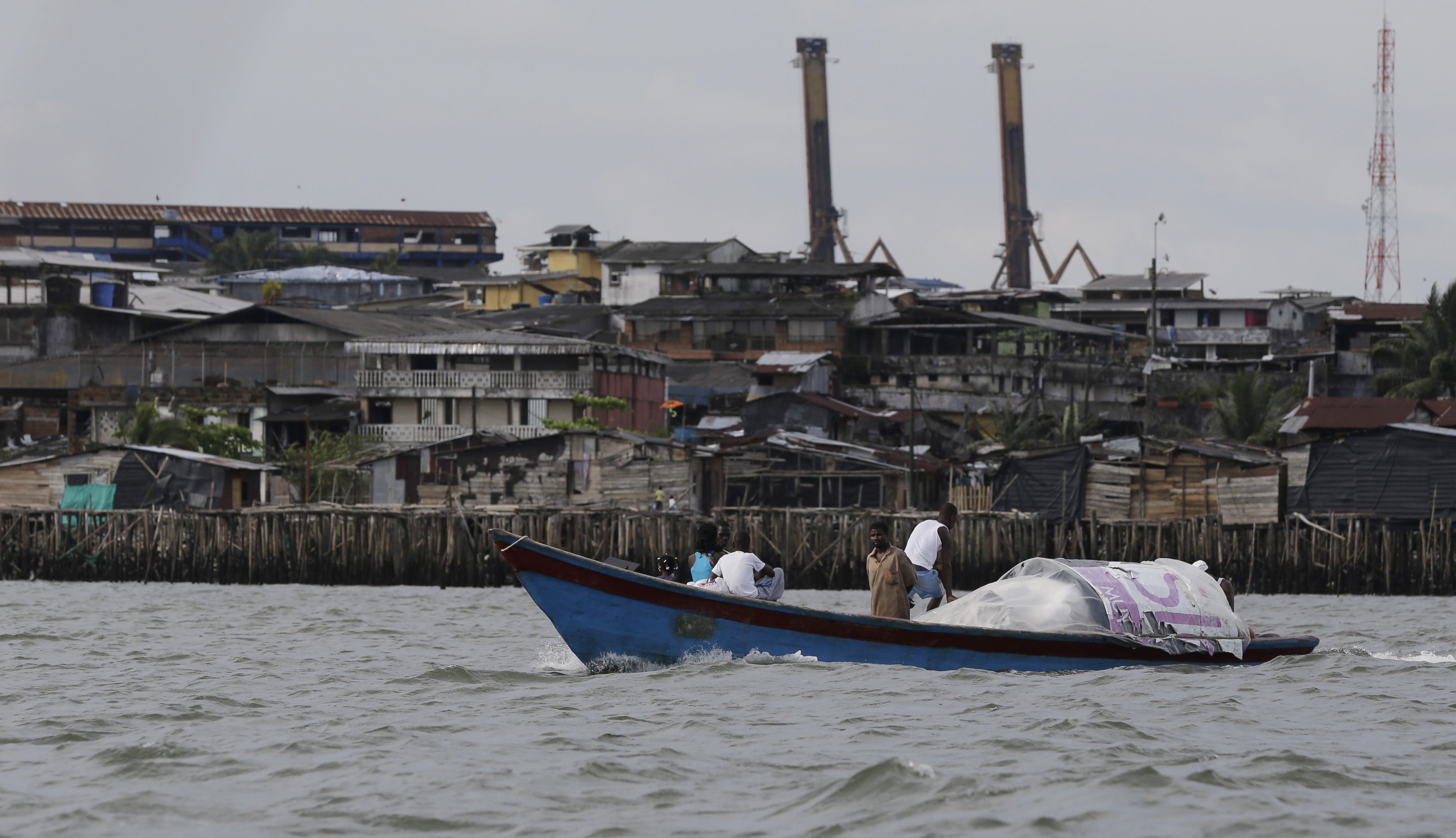 A boat cruises past Buenaventura, Colombia&#39;s main port city on the Pacific coast [File: Fernando Vergara/AP Photo]
