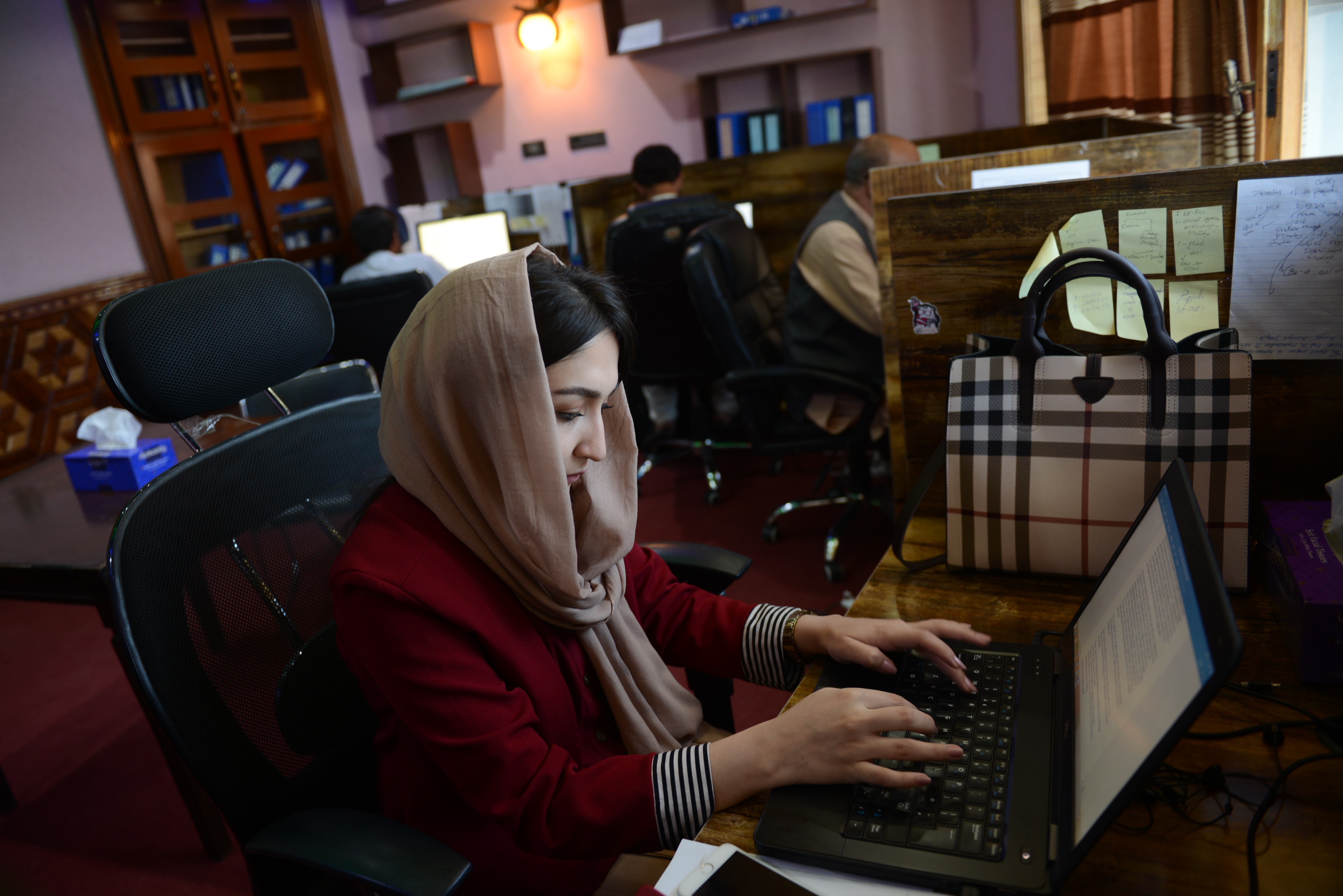Journalist Bushra Seddique works at her office in Kabul, Afghanistan [Barialai Khoshhal/Al Jazeera]