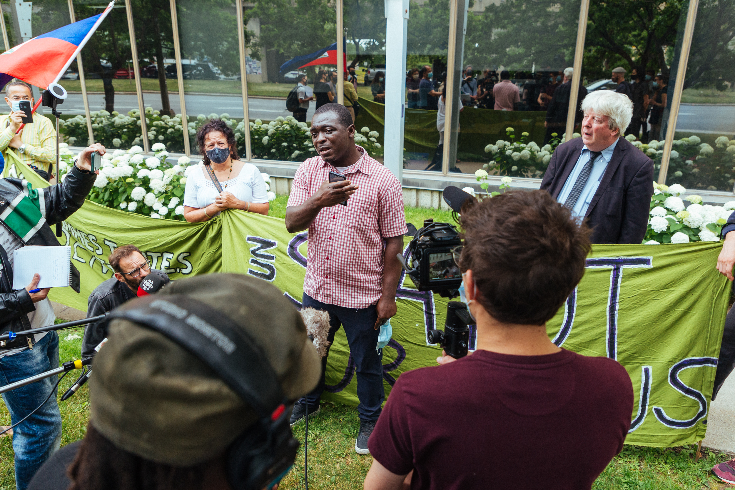 Asylum seeker Mamadou Konaté, worked as a janitor at elderly care homes in Montreal at the peak of the COVID pandemic in 2020, he now faces the threat of deportation. On July 6, he addressed a crowd gathered in front of Prime Minister Trudeau&#39;s constituency office in Montreal to protest essential worker deportations [Stacy Lee]