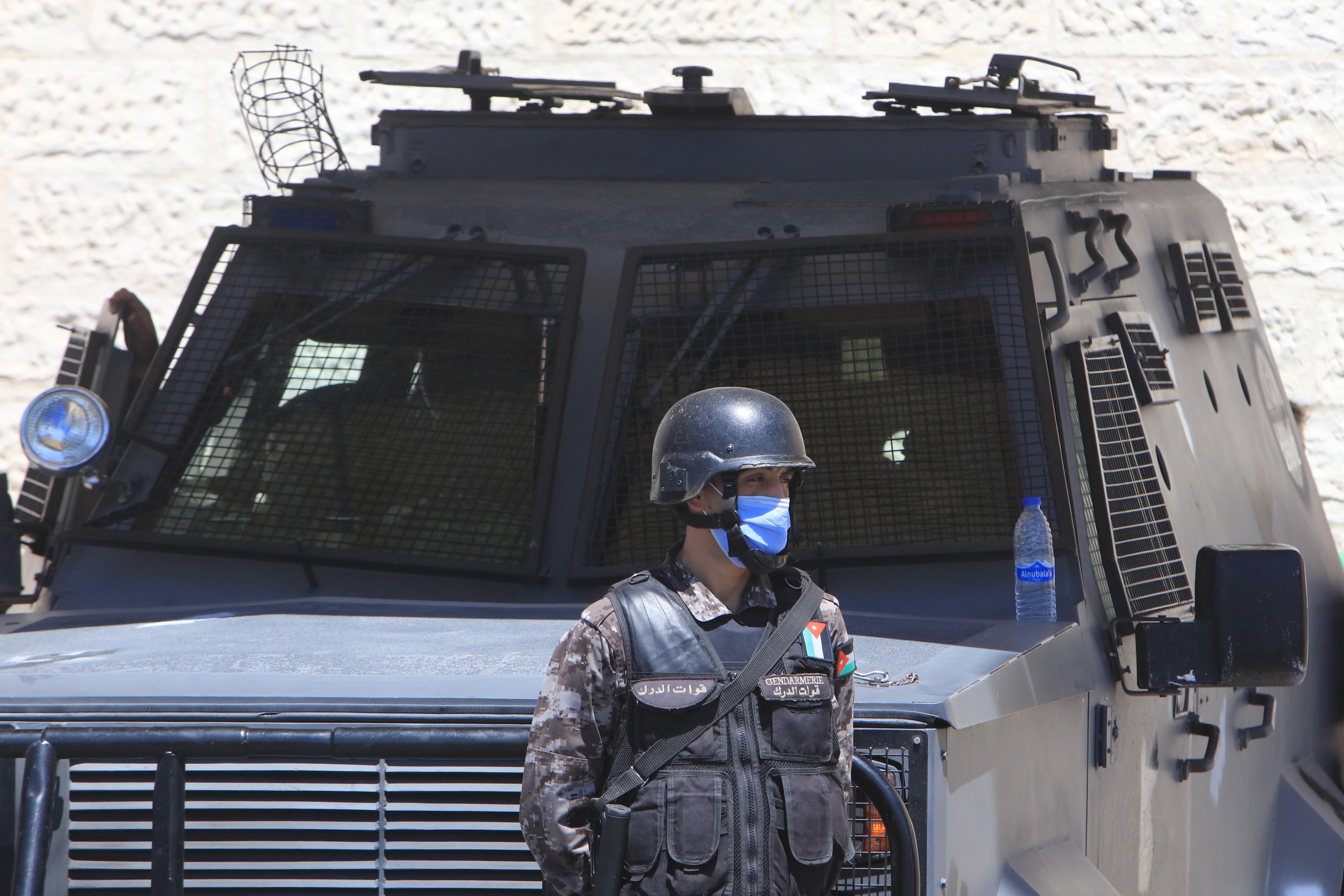 Officers stand guard outside Jordan's State Security Court, as it is set to announce its verdict in the trial of two officials accused of helping Prince Hamzah try to overthrow his half-brother King Abdullah II, in the capital Amman.