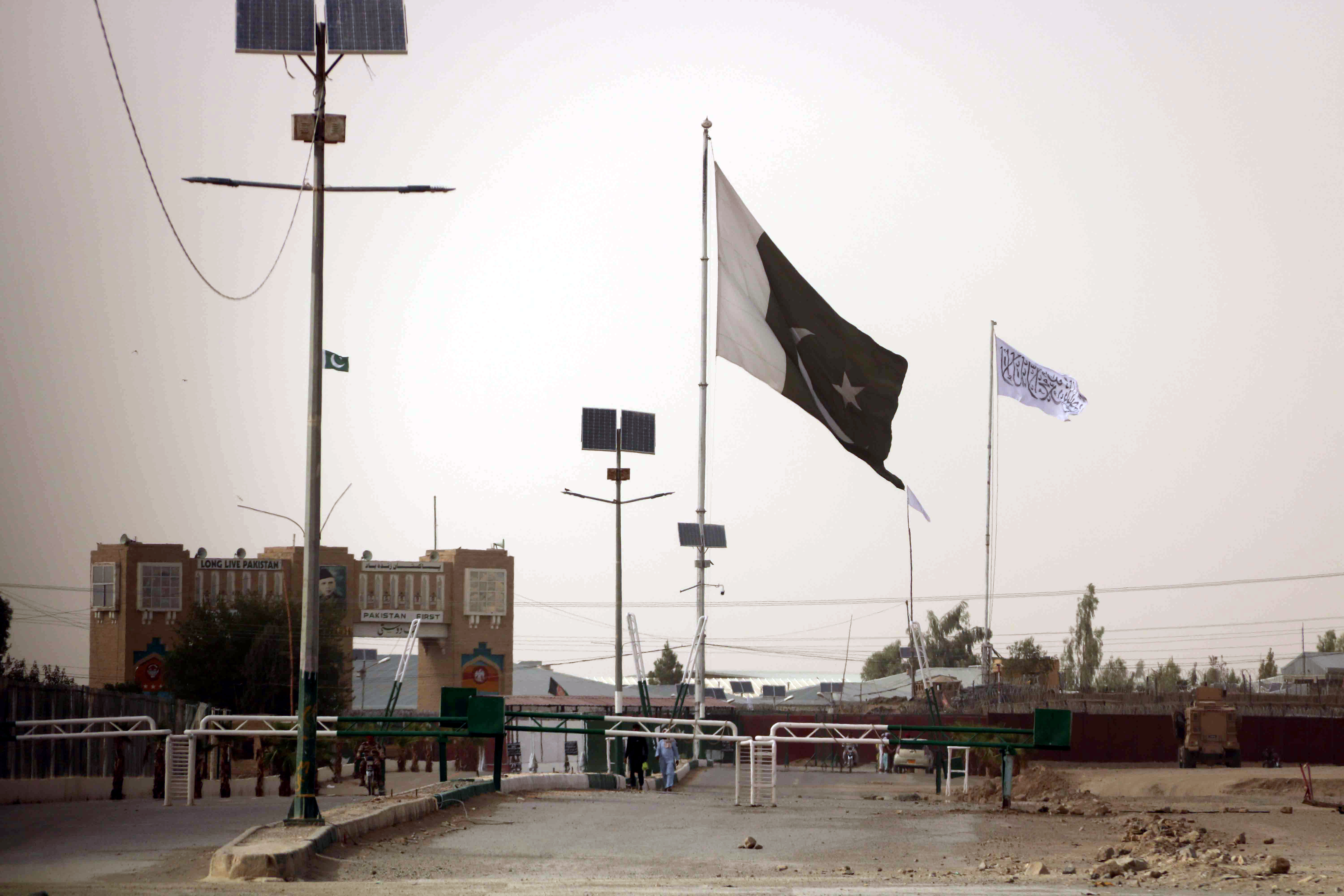 A Taliban flag is seen raised from the Afghan side of the Pakistan-Afghanistan border at Chaman, Pakistan in this July 14, 2021 photo [Akhter Gulfam/EPA]
