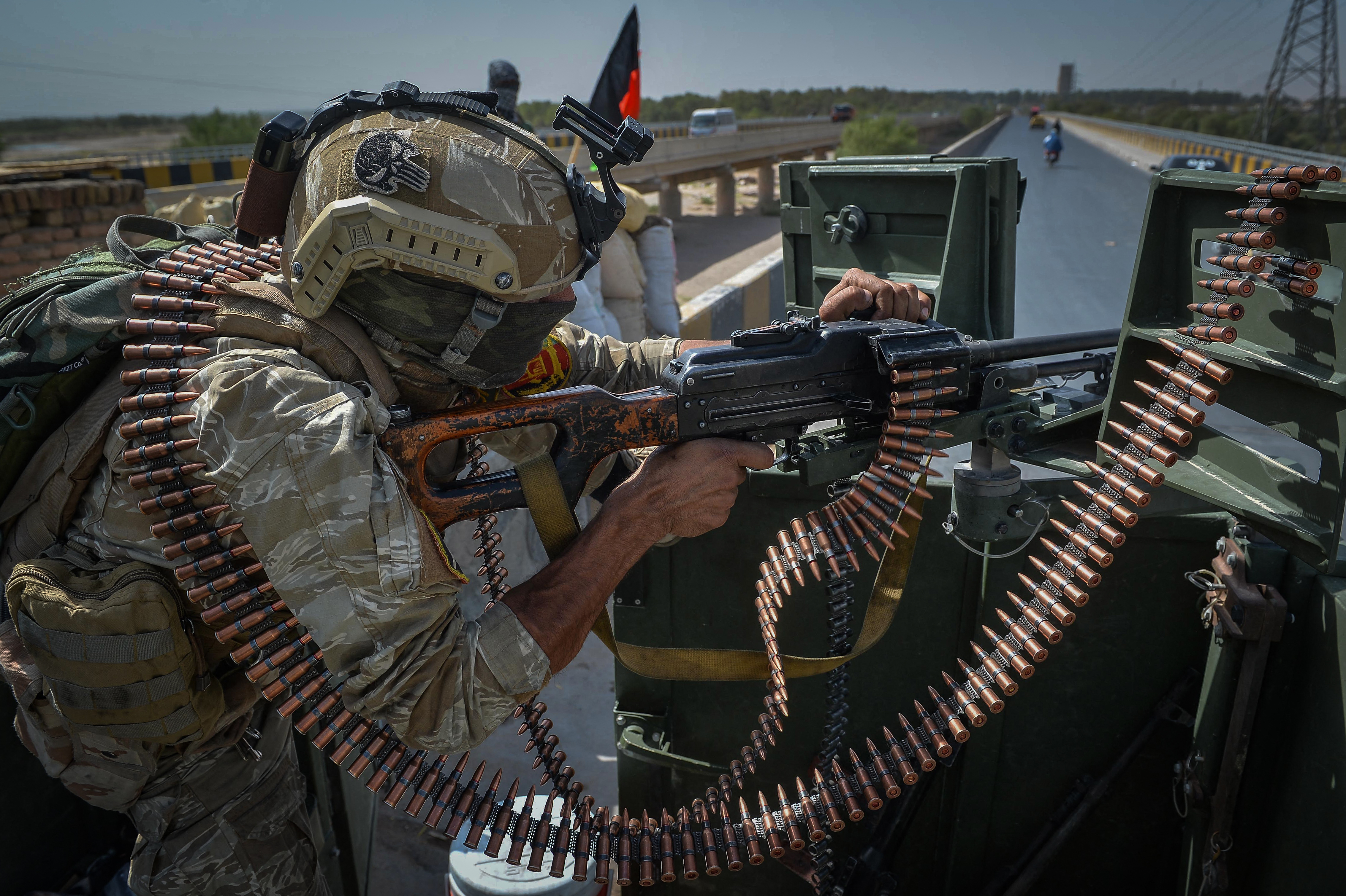 An Afghan soldier on top of a vehicle outside the UN compound in Guzara district of Herat province [Hoshang Hashimi/AFP]