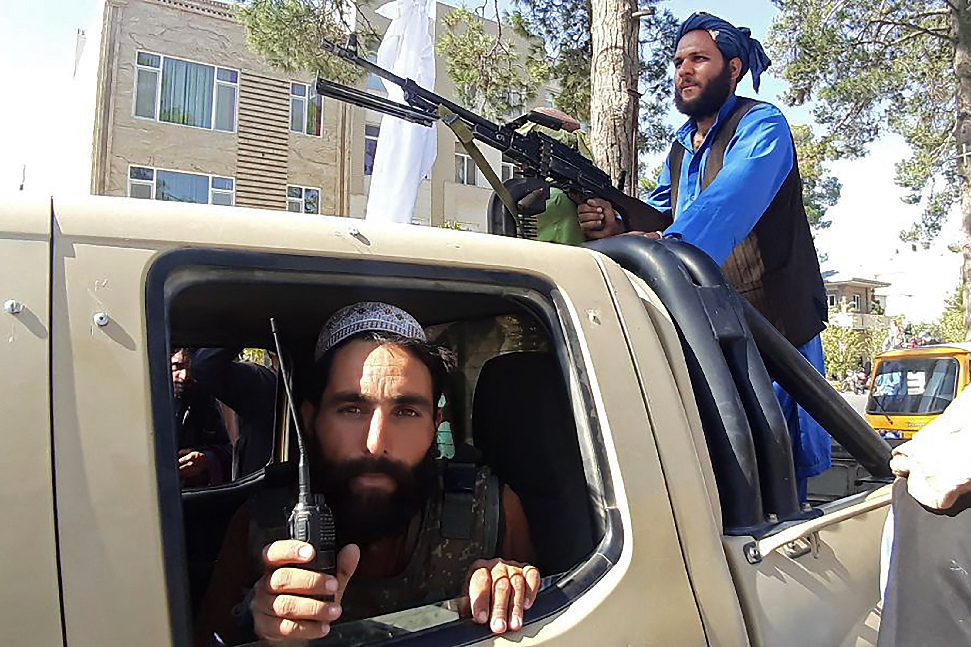 Taliban fighters are seen in a vehicle along the roadside in Herat, Afghanistan&#39;s third biggest city, after government forces pulled out the day before following weeks of being under siege [AFP]