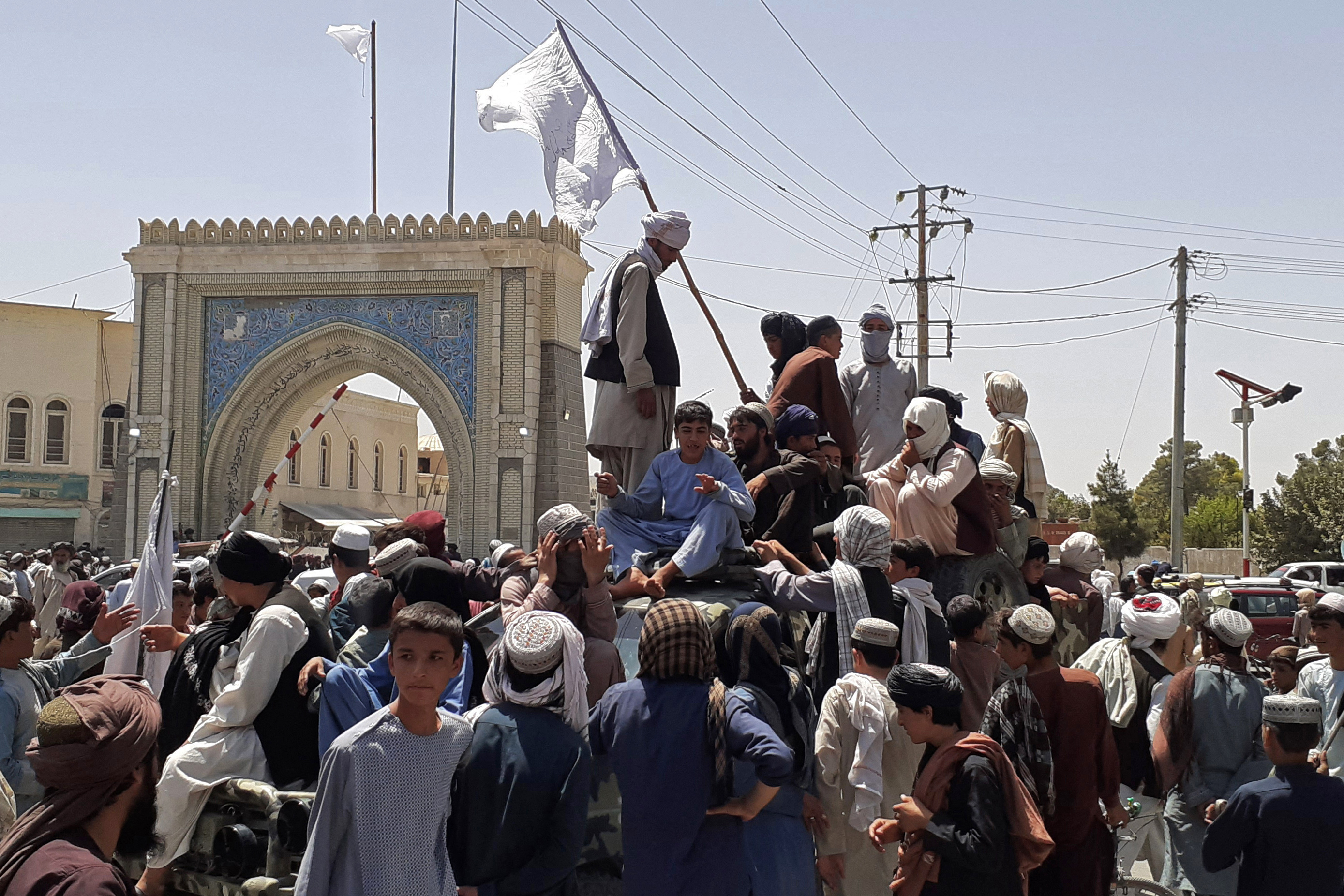 Taliban fighters stand on a vehicle along the roadside in Kandahar on August 13, 2021 [AFP]