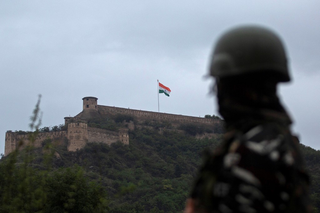 In this photo taken on August 15, 2021, an Indian soldier stands guard as India&#39;s national flag flutters on Hari Parbat Fort in Srinagar to mark India&#39;s 75th Independence Day [File: Abid Bhat/AFP]