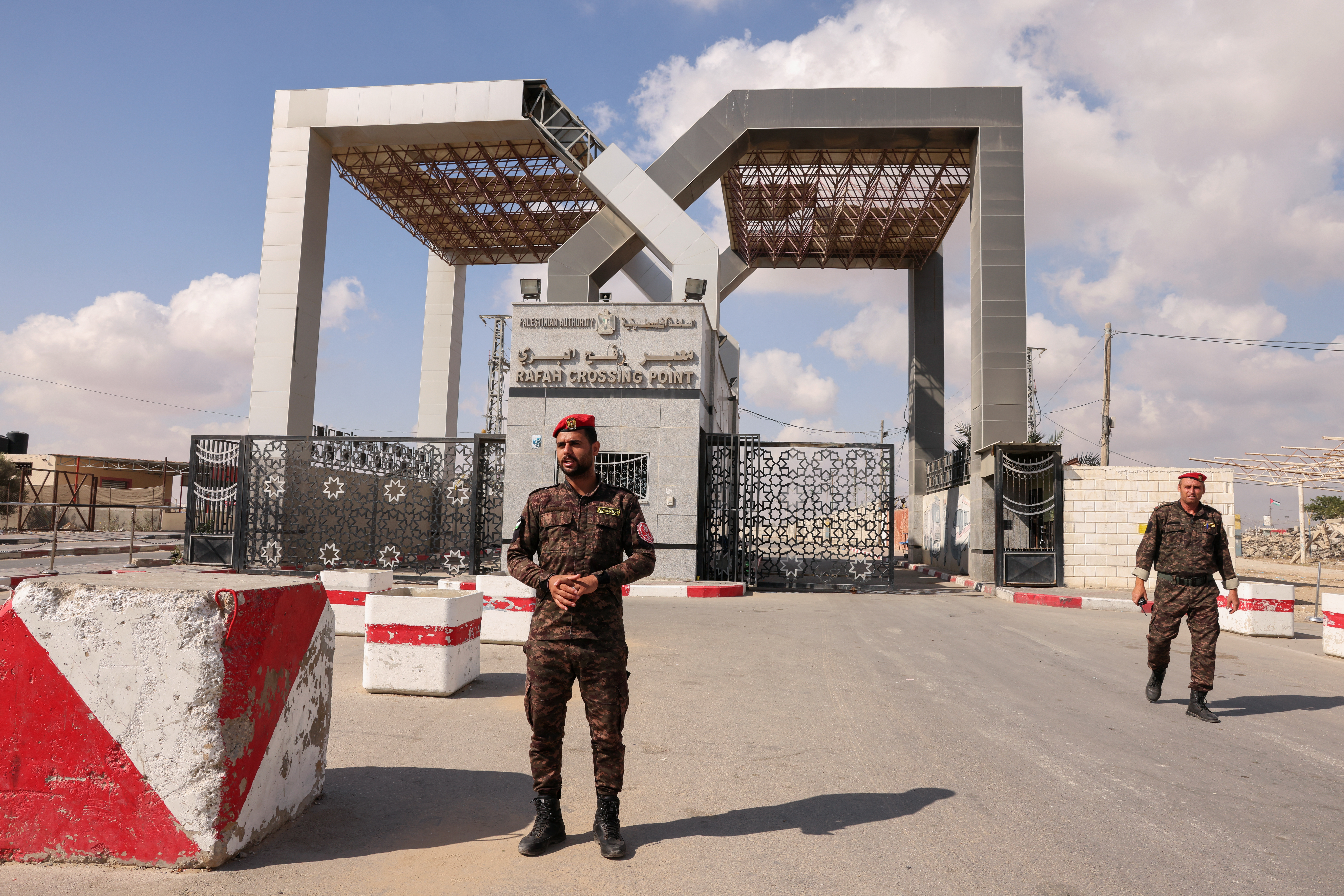 Members of Palestinian security forces stand guard at the closed-off Rafah border crossing to Egypt in the southern Gaza Strip [Said Khatib/AFP]