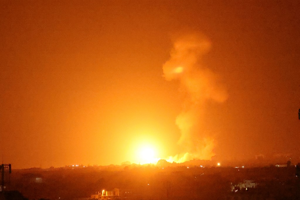 A fireball rises following an air raid in Khan Yunis in the southern Gaza Strip, late on August 23, 2021 [Said Khatib/AFP]