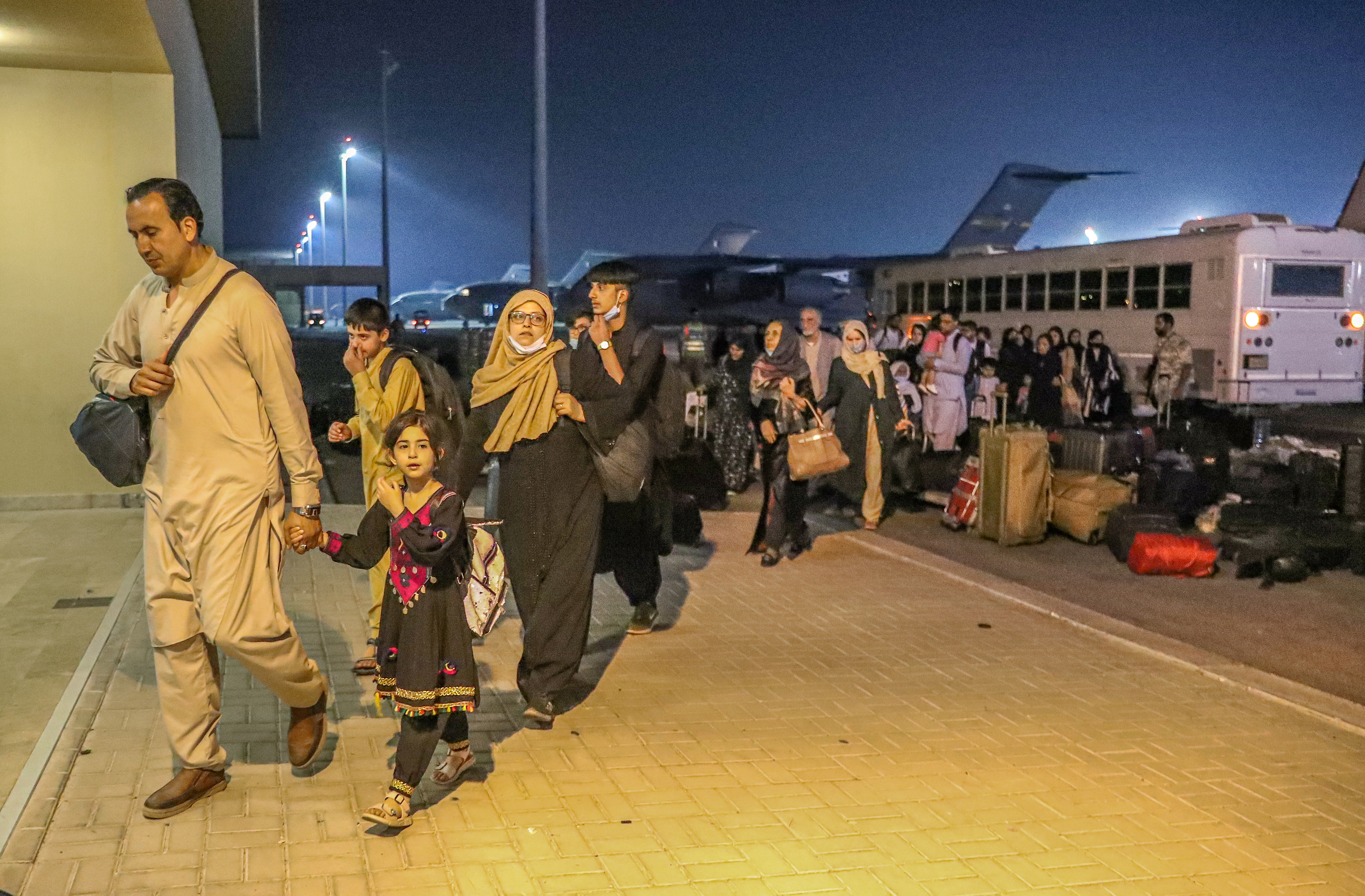 Evacuees from Afghanistan arrive at the Al Udeid airbase in Doha, Qatar [Reuters]