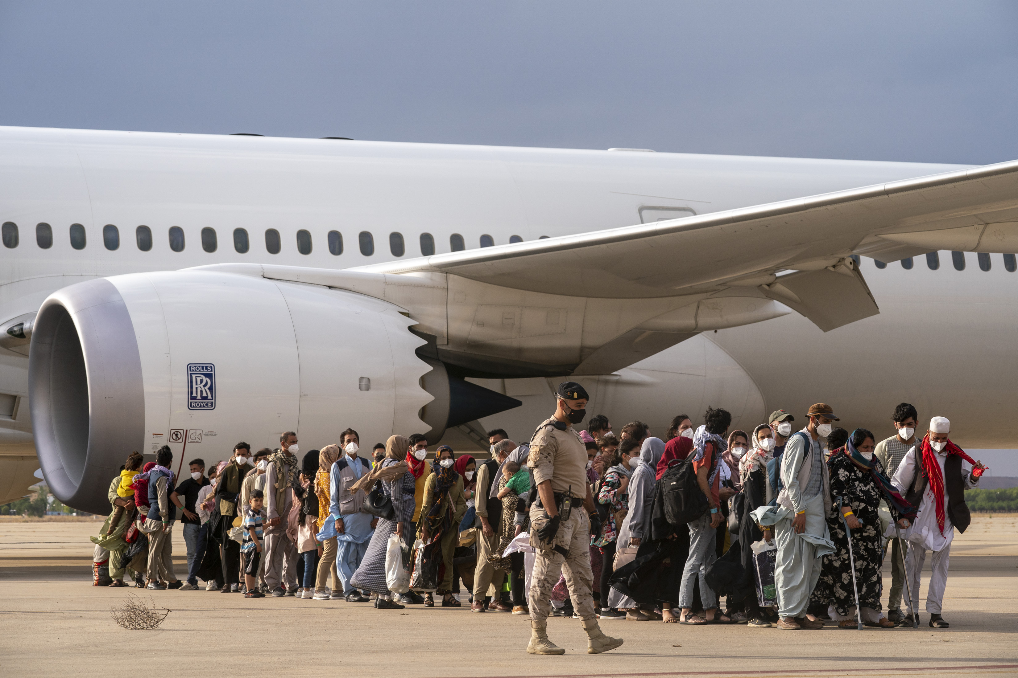 Afghans disembark a plane at the Torrejon military base in Madrid, Spain [File: Andrea Comas/The Associated Press]