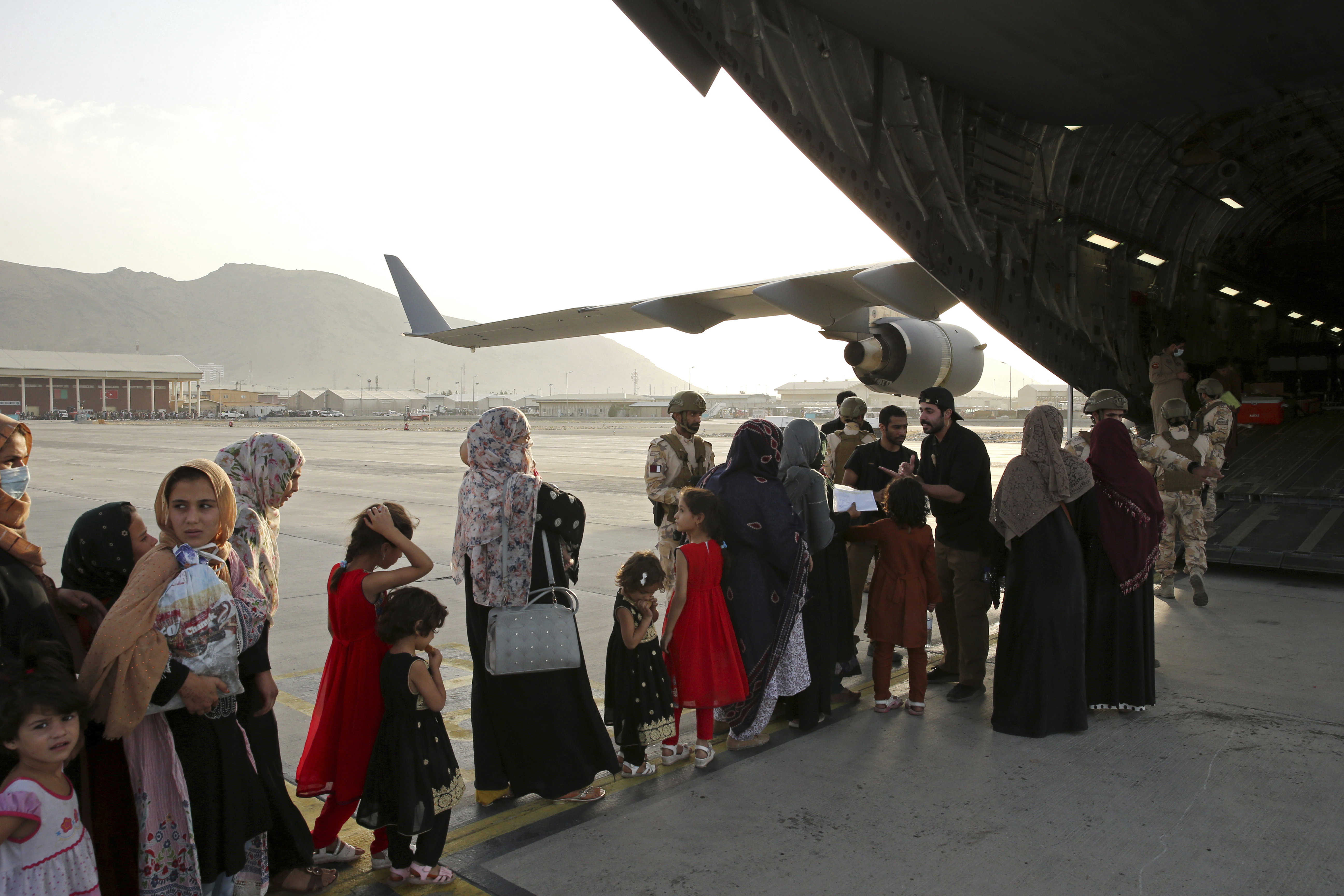 Afghans evacuated aboard a Qatari transport plane