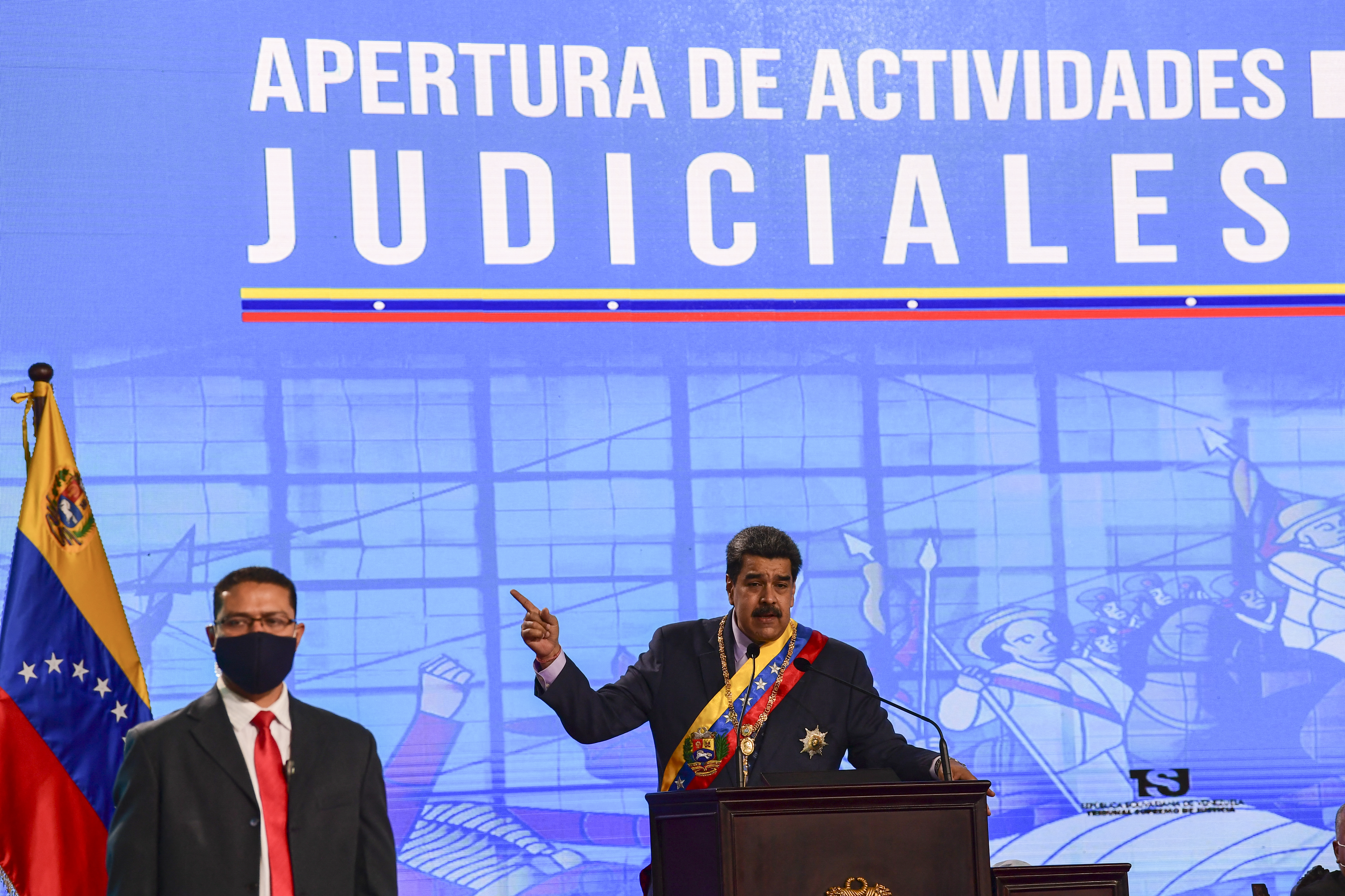 Venezuelan President Nicolas Maduro delivers a speech next to a bodyguard during opening ceremony of the judicial year at the Supreme Tribunal of Justice building in Caracas [File: Yuri Cortez/AFP]