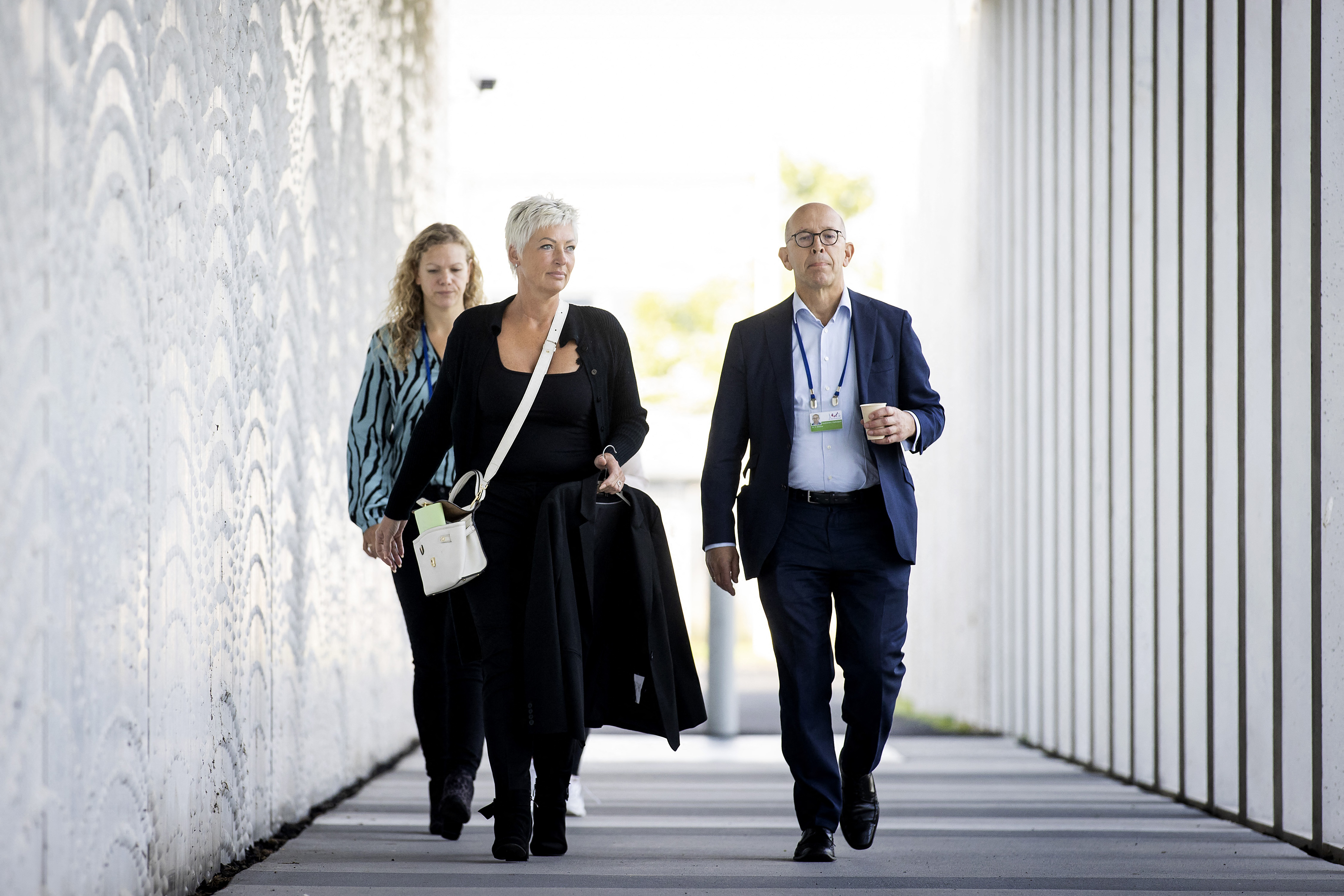 Spokesperson for victims&#39; relatives Ria van der Steen, centre, arrives at the Schiphol Judicial Complex in Badhoevedorp [Koen van Weel/ ANP via AFP]