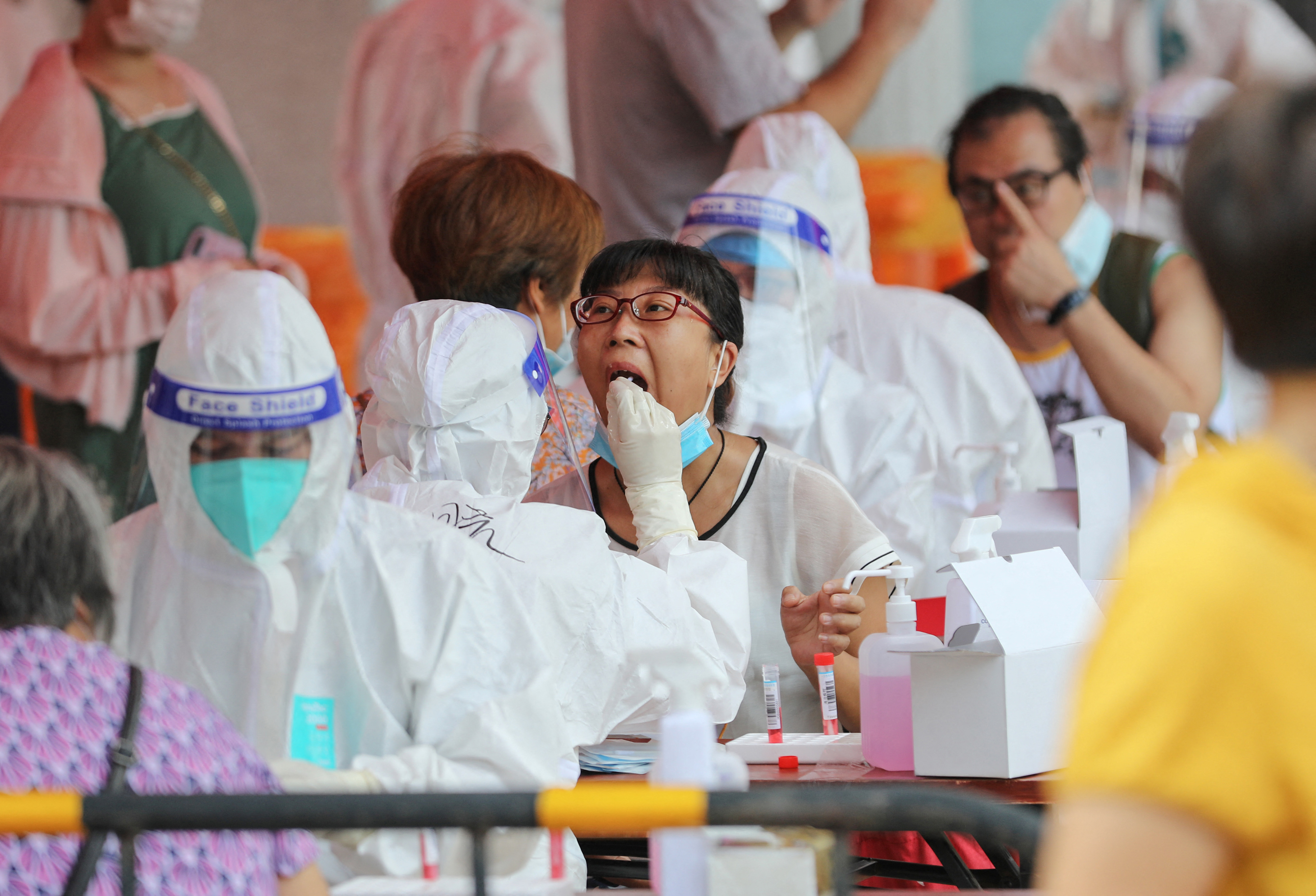 A resident undergoes a nucleic acid test for the COVID-19 coronavirus in Xiamen, in China&#39;s eastern Fujian province on September 14 [Stringer/AFP]