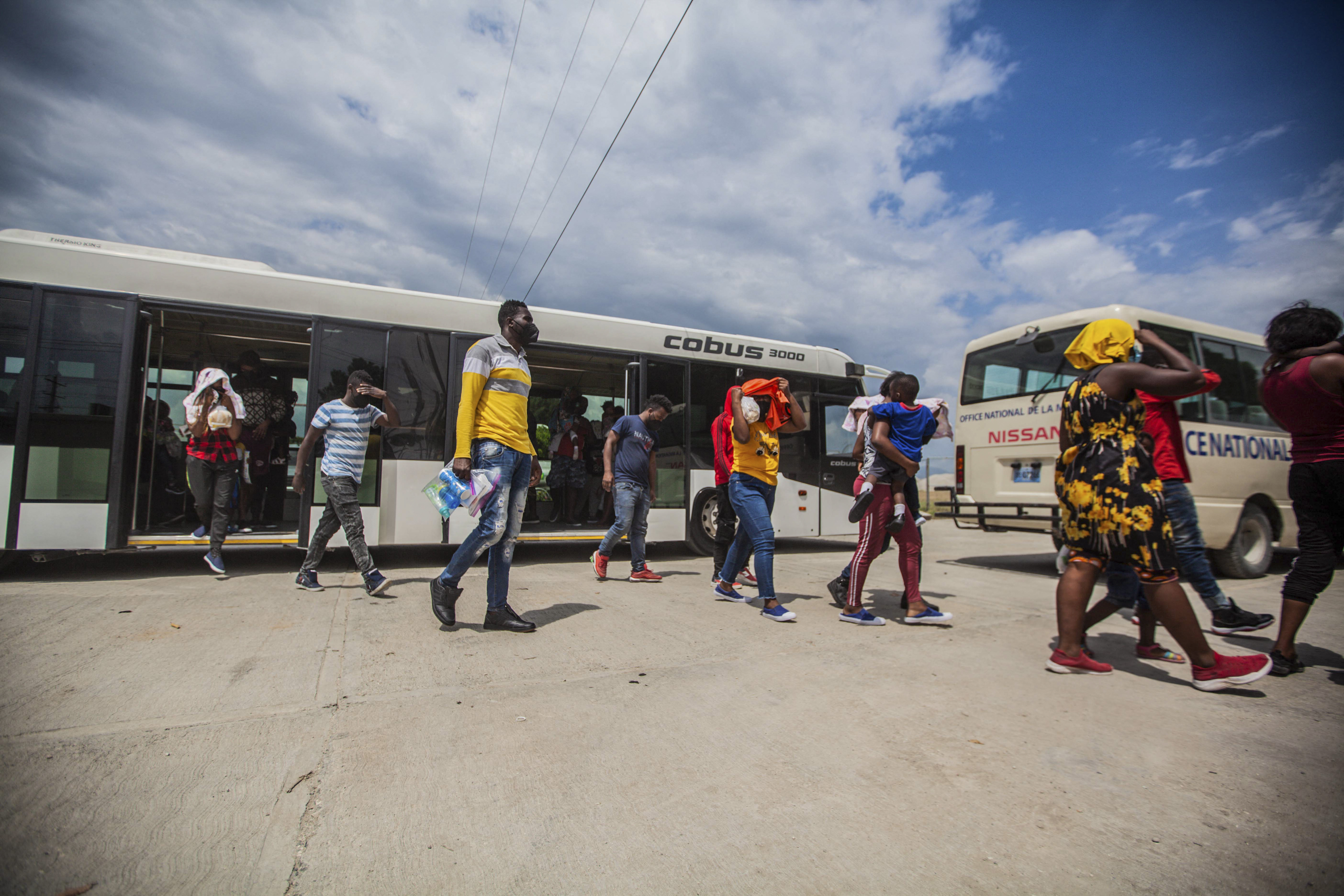 Haitian migrants arrive at the airport in Port-au-Prince after being expelled from the United States [File: Richard Pierrin/AFP]