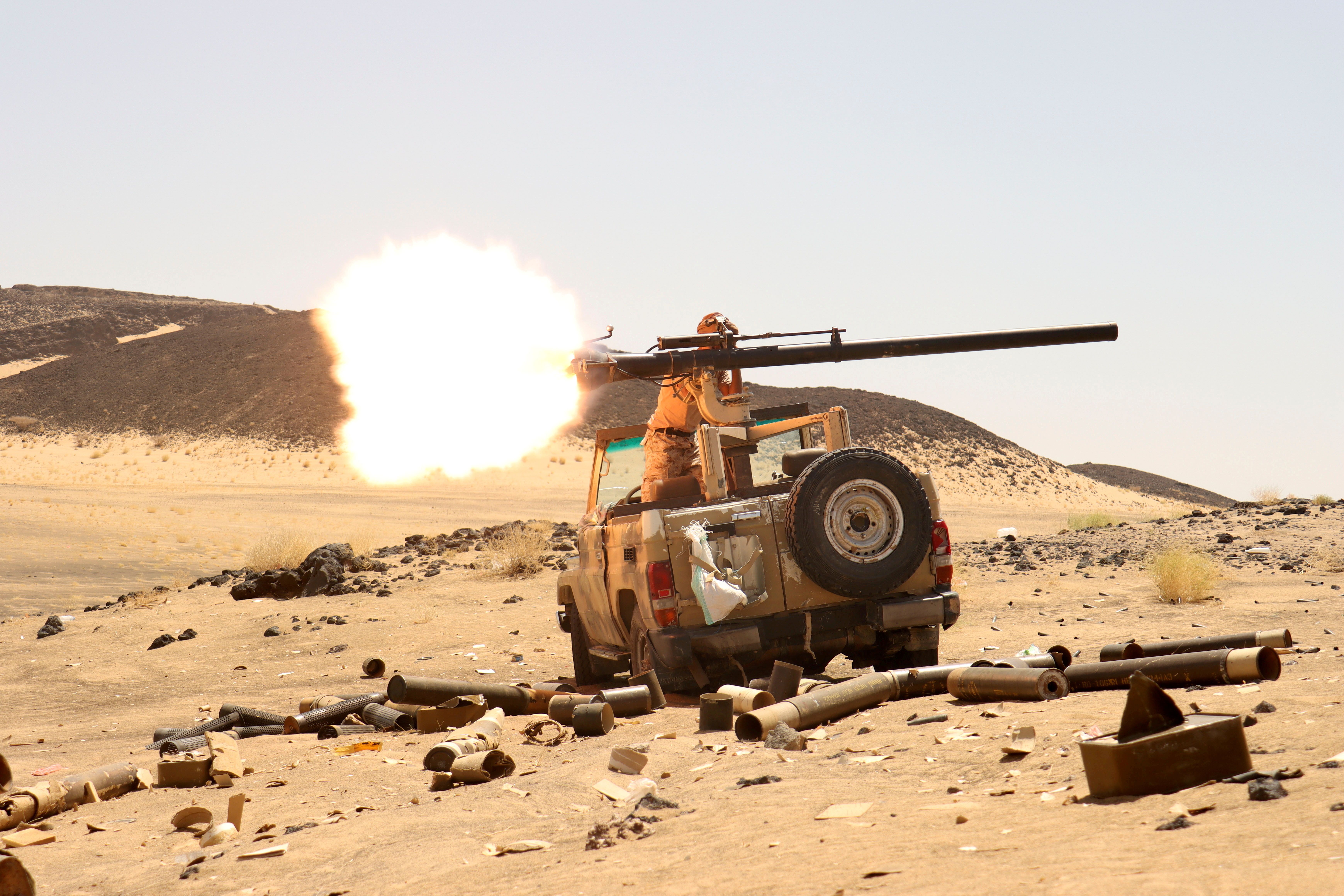 A Yemeni government fighter fires a vehicle-mounted weapon at a front-line position during battles against Houthi rebels in Marib [File: Ali Owidha/Reuters]