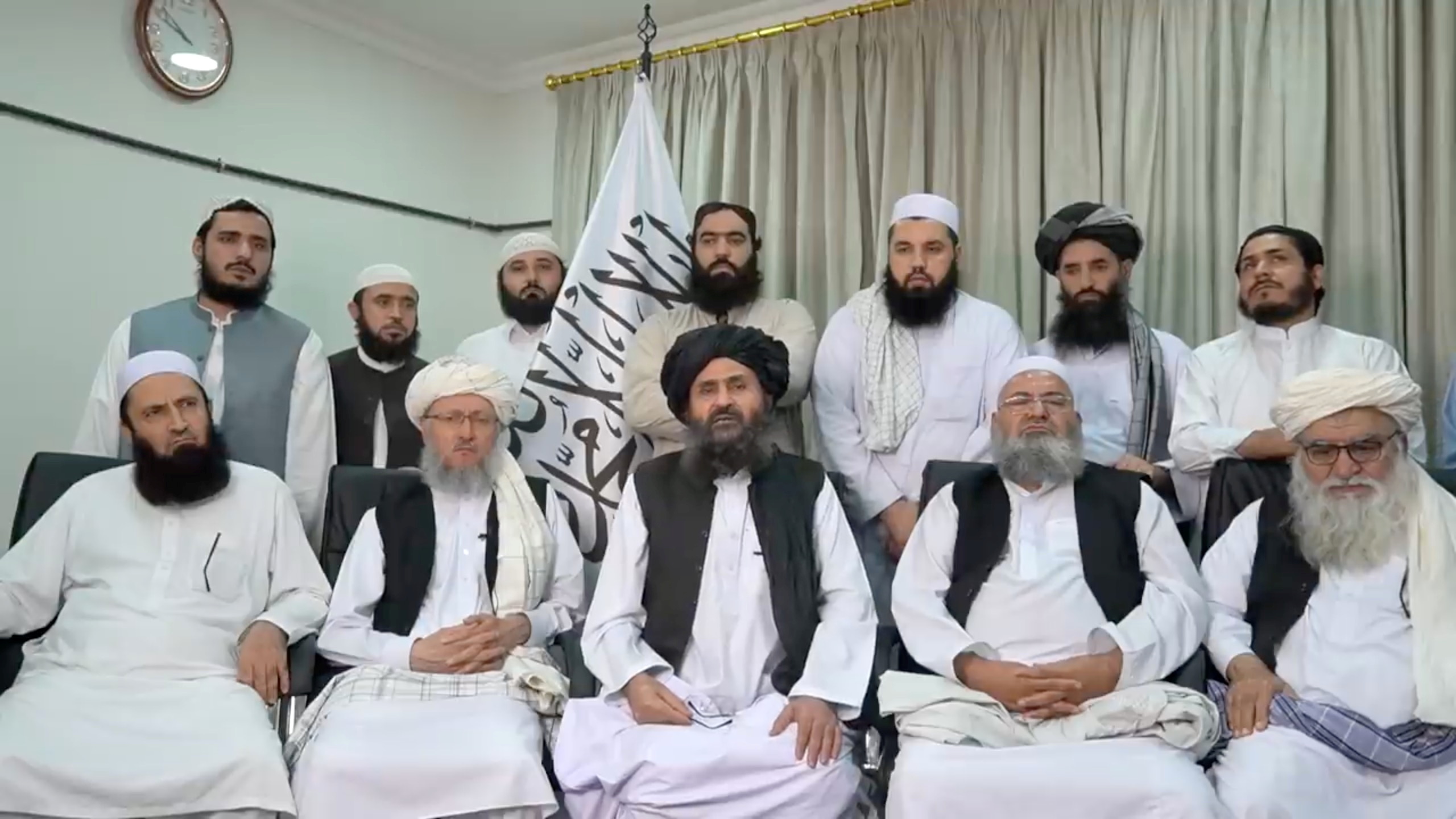 Mullah Baradar Akhund, centre, a senior Taliban official, seated with a group of men in this photo taken from a video released on August 16, 2021 [File: Social Media/via Reuters]