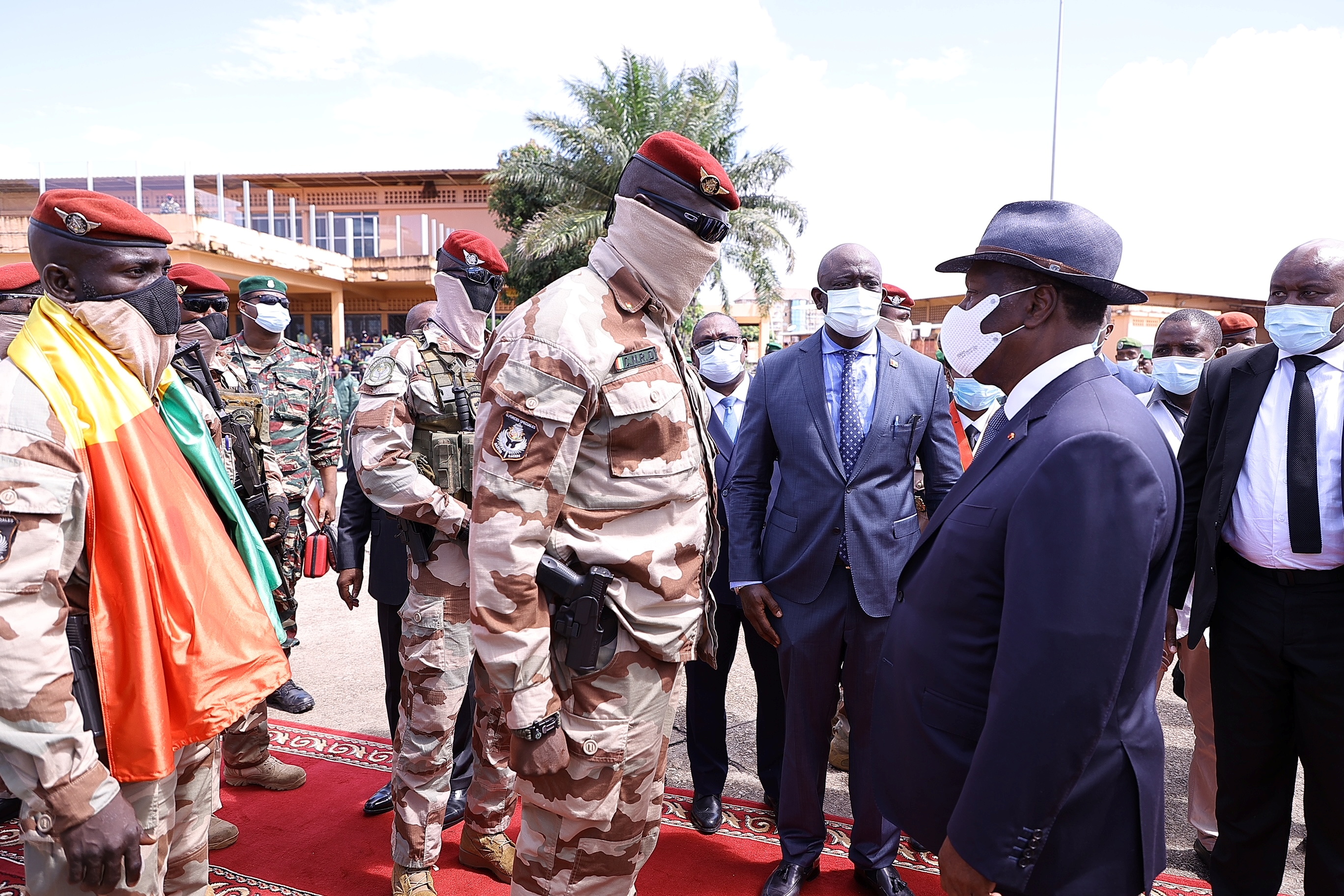 Colonel Mamady Doumbouya, left, who deposed President Alpha Conde earlier in September, greets Ivory Coast&#39;s President Alassane Ouattara, right [File: Ivory Coast Presidency/Reuters]