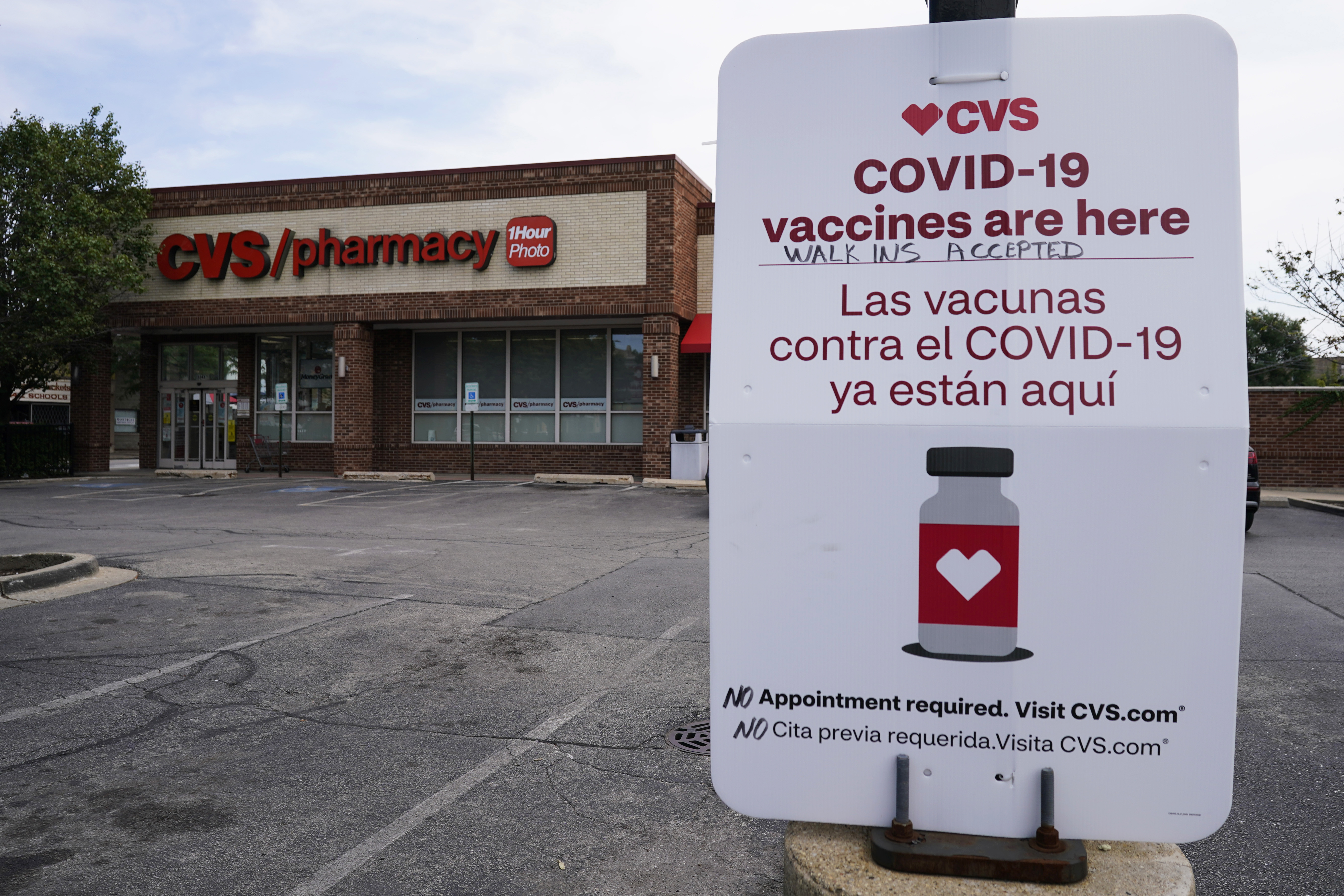 An information sign regarding COVID-19 vaccines is seen outside of a CVS store in Chicago, Illinois [File: Nam Y. Huh/AFP]