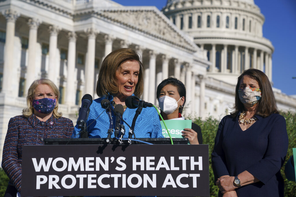 Democratic US lawmakers, House Speaker Nancy Pelosi with Representatives Sylvia Garcia, Judy Chu and Diana DeGette, hold a news conference just before a House vote on Friday, approving legislation guaranteeing a woman’s right to an abortion [J Scott Applewhite/AP Photo]