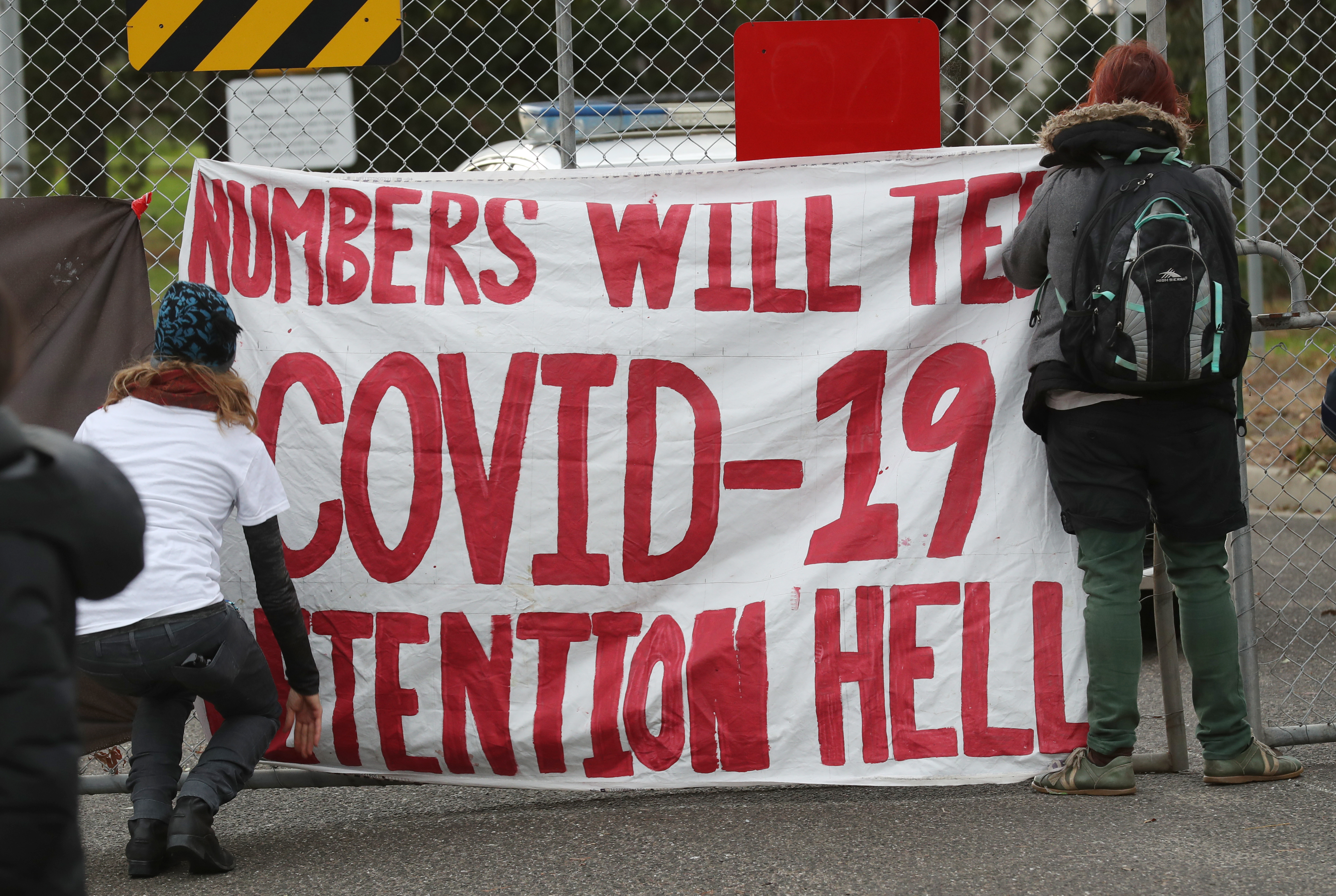 Activists - seen here at a &#39;Free The Refugees&#39; rally at the Melbourne Immigration Transit Accommodation Centre in June 2020 - have been concerned for months over the risk of COVID-19 in detention centres [File: David Crosling/EPA]