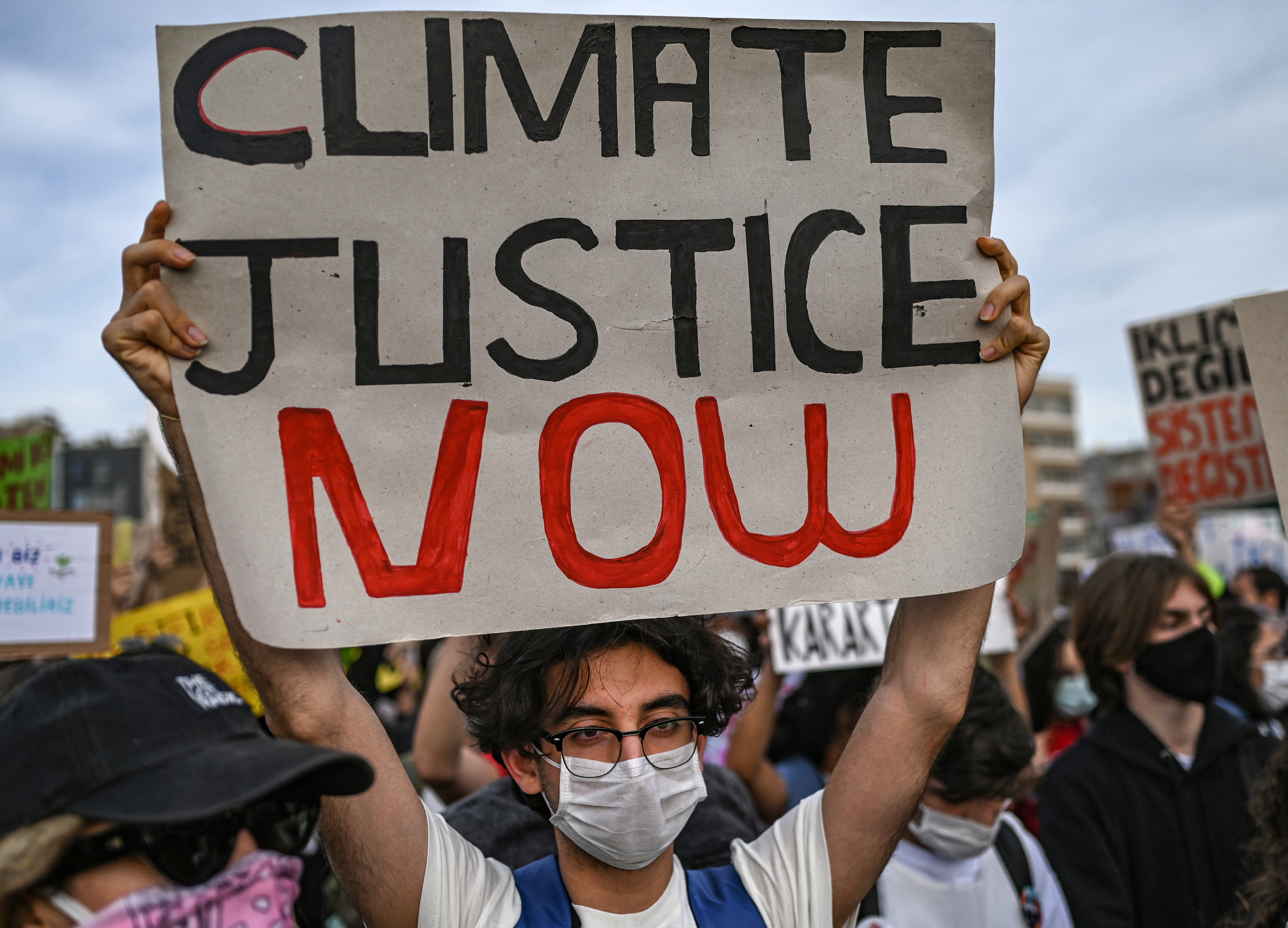 A man holds a sign during a climate change protest in Kadikoy district, Istanbul, in September [File: Ozan Kose/AFP]