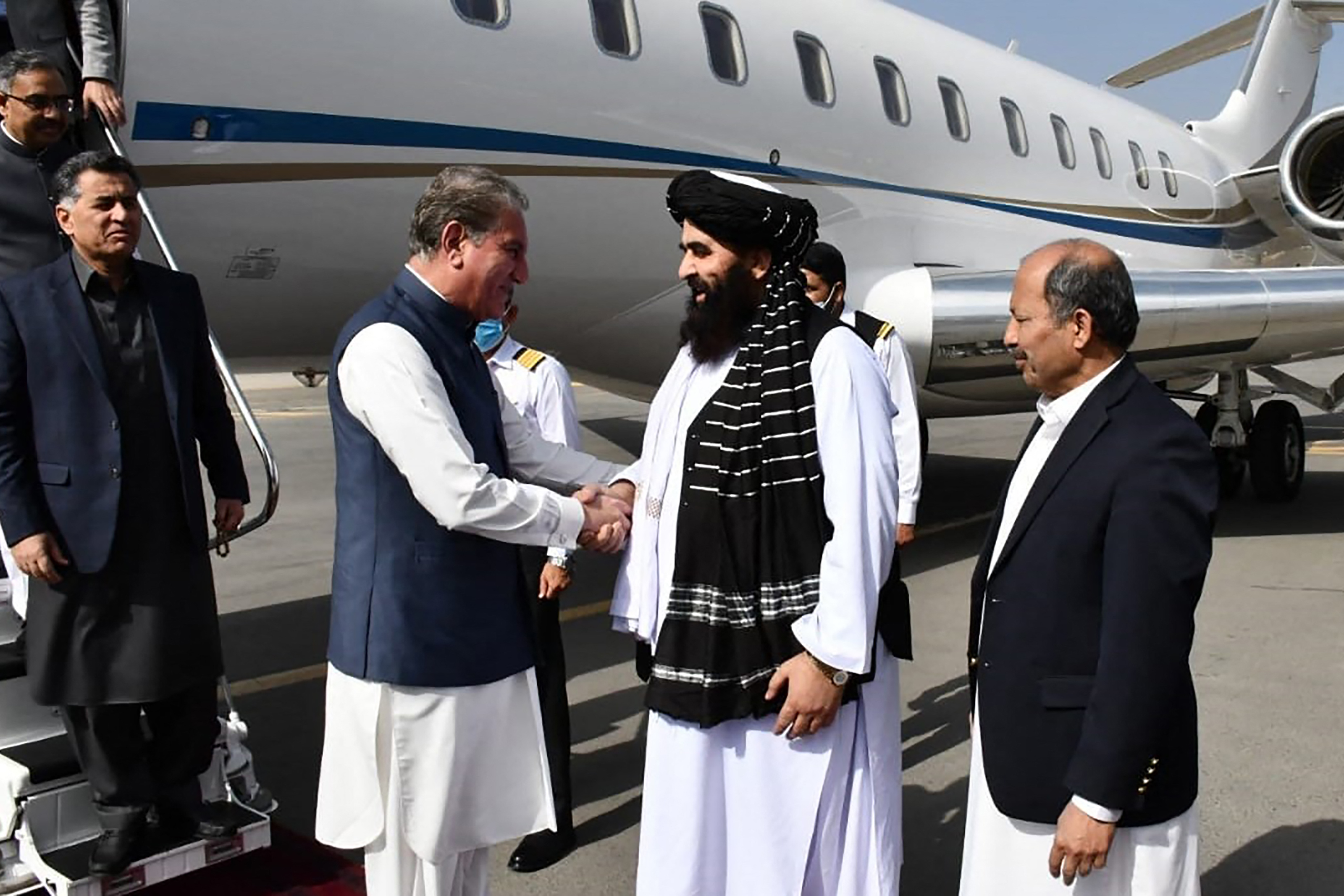 Afghanistan&#39;s acting Foreign Minister Amir Khan Muttaqi, right, welcomes Pakistan&#39;s Foreign Minister Shah Mahmood Qureshi in Kabul [Pakistan Foreign Office/AFP]
