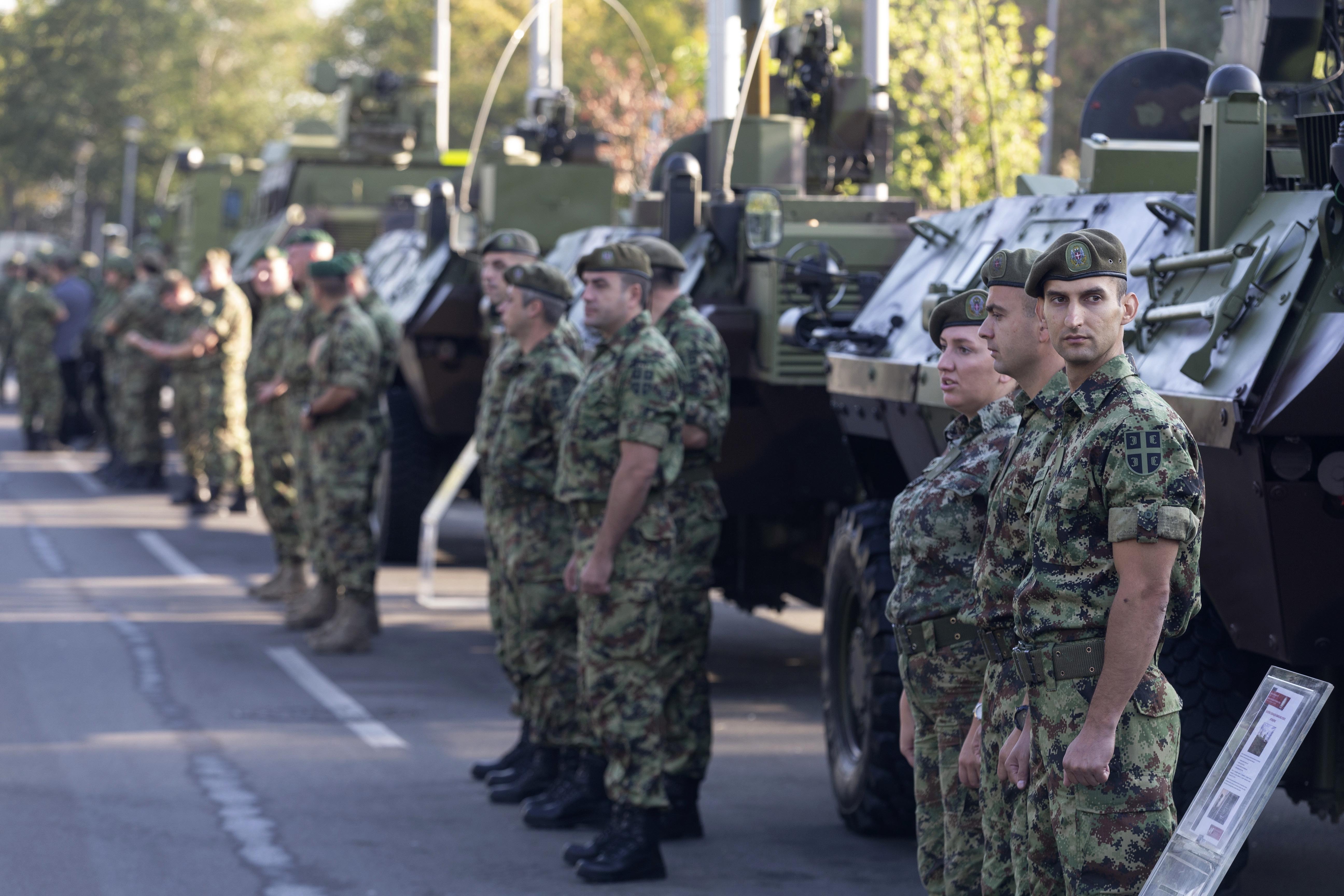 Serbian soldiers stand in front of armored personnel carriers as part of a new &#39;Serbian Unity Day&#39; holiday in Belgrade [Marko Drobnjakovic/AP]