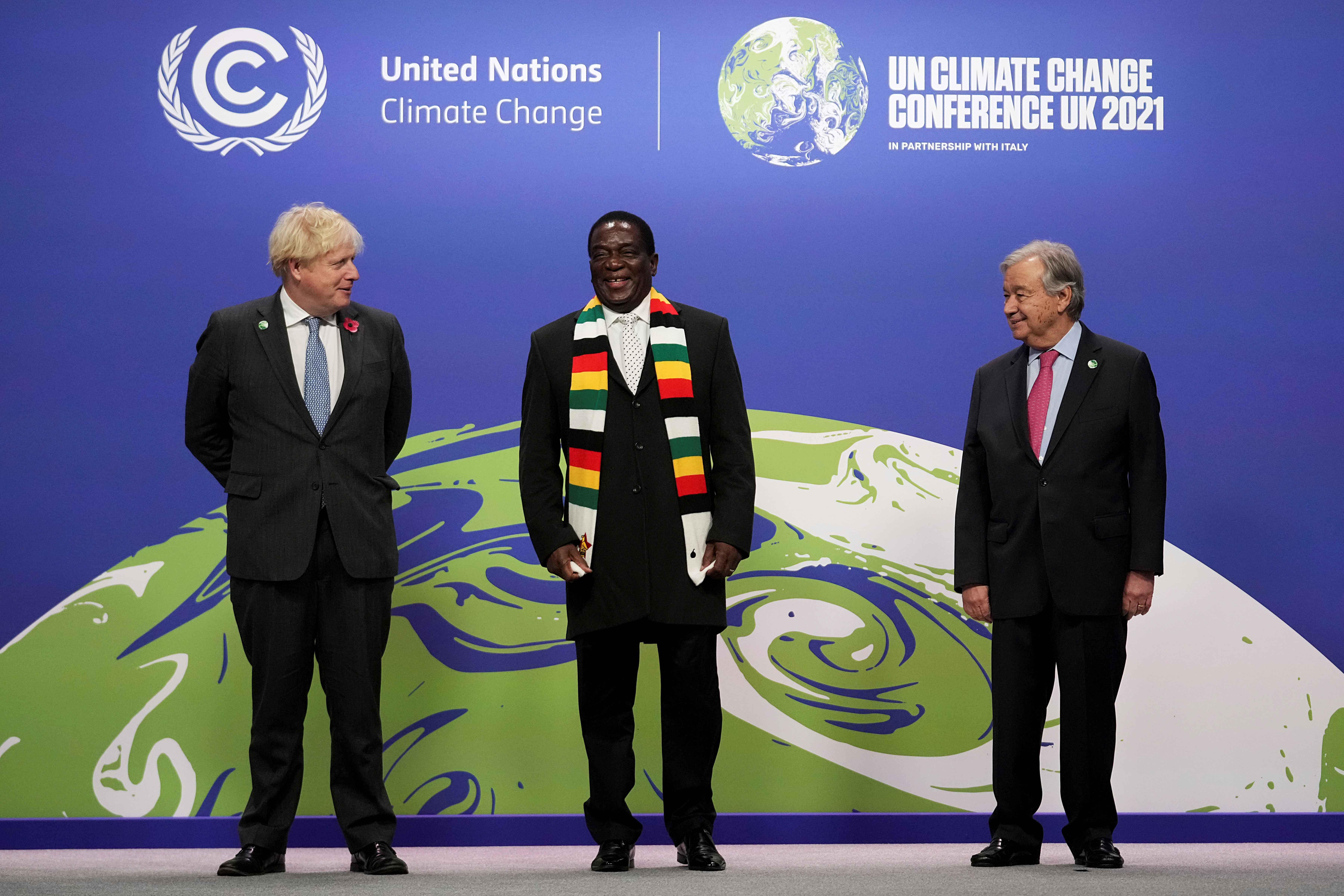 Zimbabwe&#39;s President Emmerson Mnangagwa, centre, poses with UN Secretary-General Antonio Guterres, right, and British Prime Minister Boris Johnson as he arrives for the COP26 on November 1 [Reuters/Christopher Furlong]