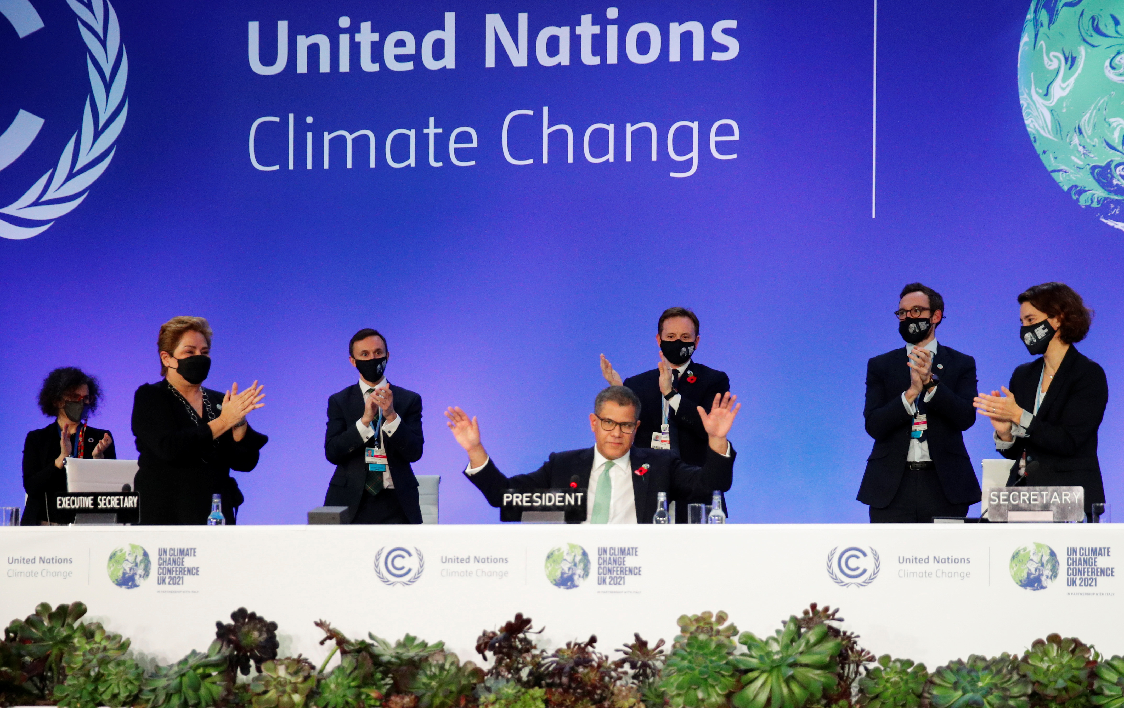 COP26 President Alok Sharma gestures as he receives applause during COP26, the UN Climate Change Conference in Glasgow on November 13, 2021 [Phil Noble/ Reuters]