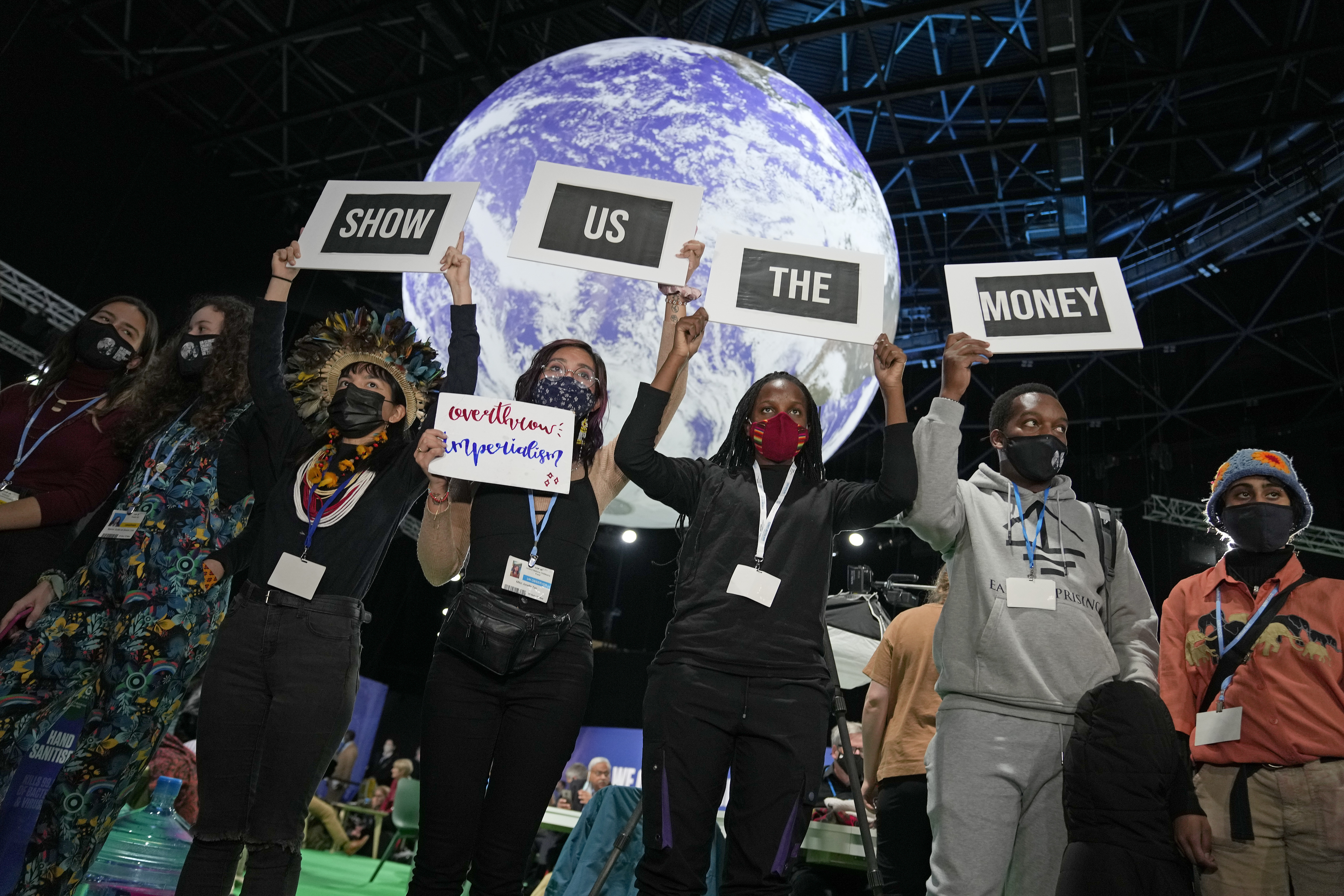 Climate activist Vanessa Nakate, third right, and other activists engage in a &#39;Show US The Money&#39; protest at the COP26 United Nations Climate Summit in Glasgow, Scotland on Monday, November 8, 2021. The summit gathers leaders from around the world, in Scotland&#39;s biggest city, to lay out their vision for addressing the common challenge of global warming [AP Photo/Alastair Grant]