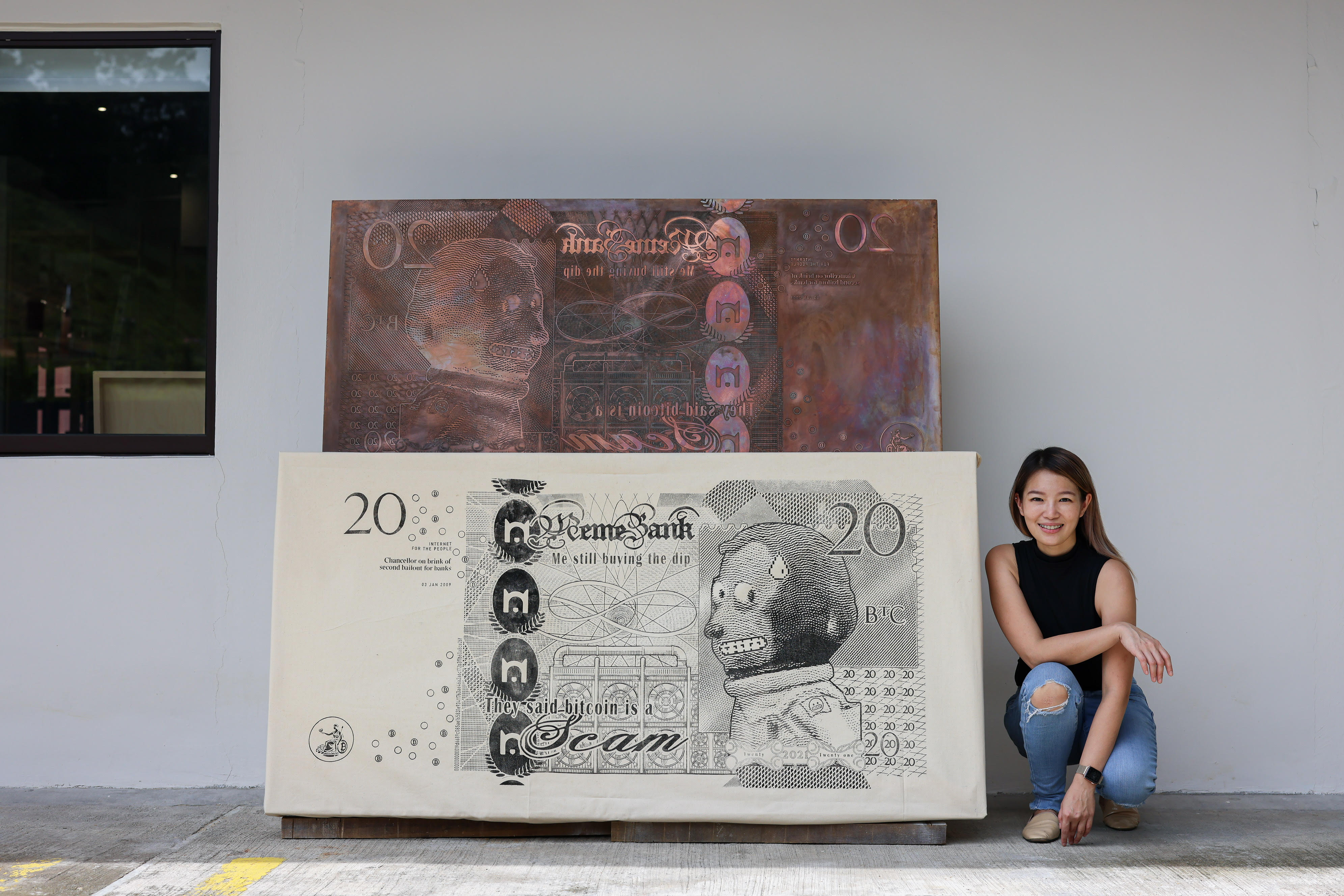 Artist Red Hong Yi with one of the six physical copper plates and prints that make up Memebank [Supplied/Annice Lyn)