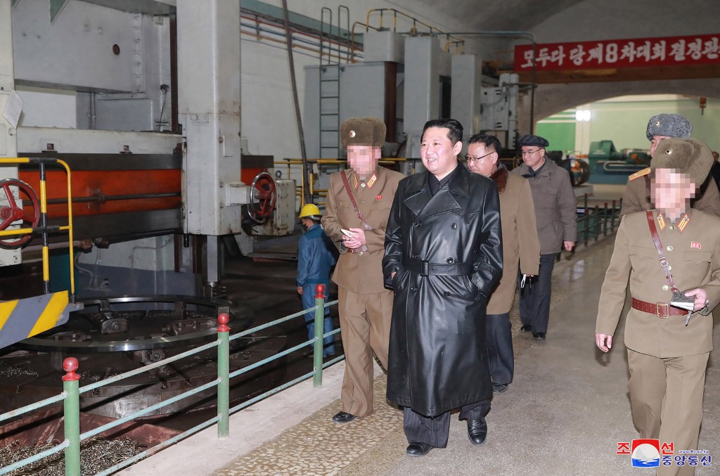 North Korean leader Kim Jong Un inspecting a munitions factory.